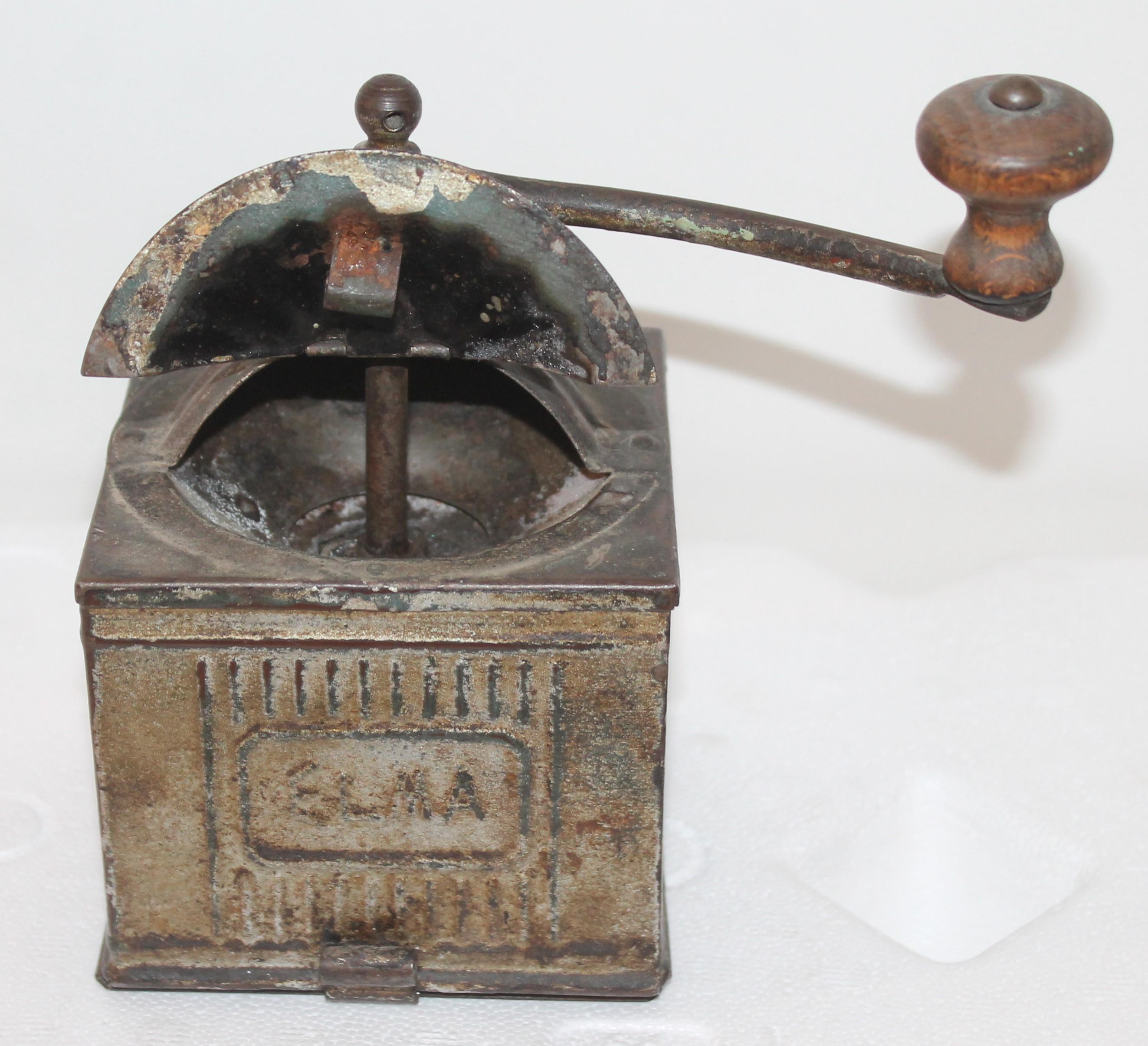 This silver-grey original painted tin coffee grinder in fantastic as found condition. This has the original crank.