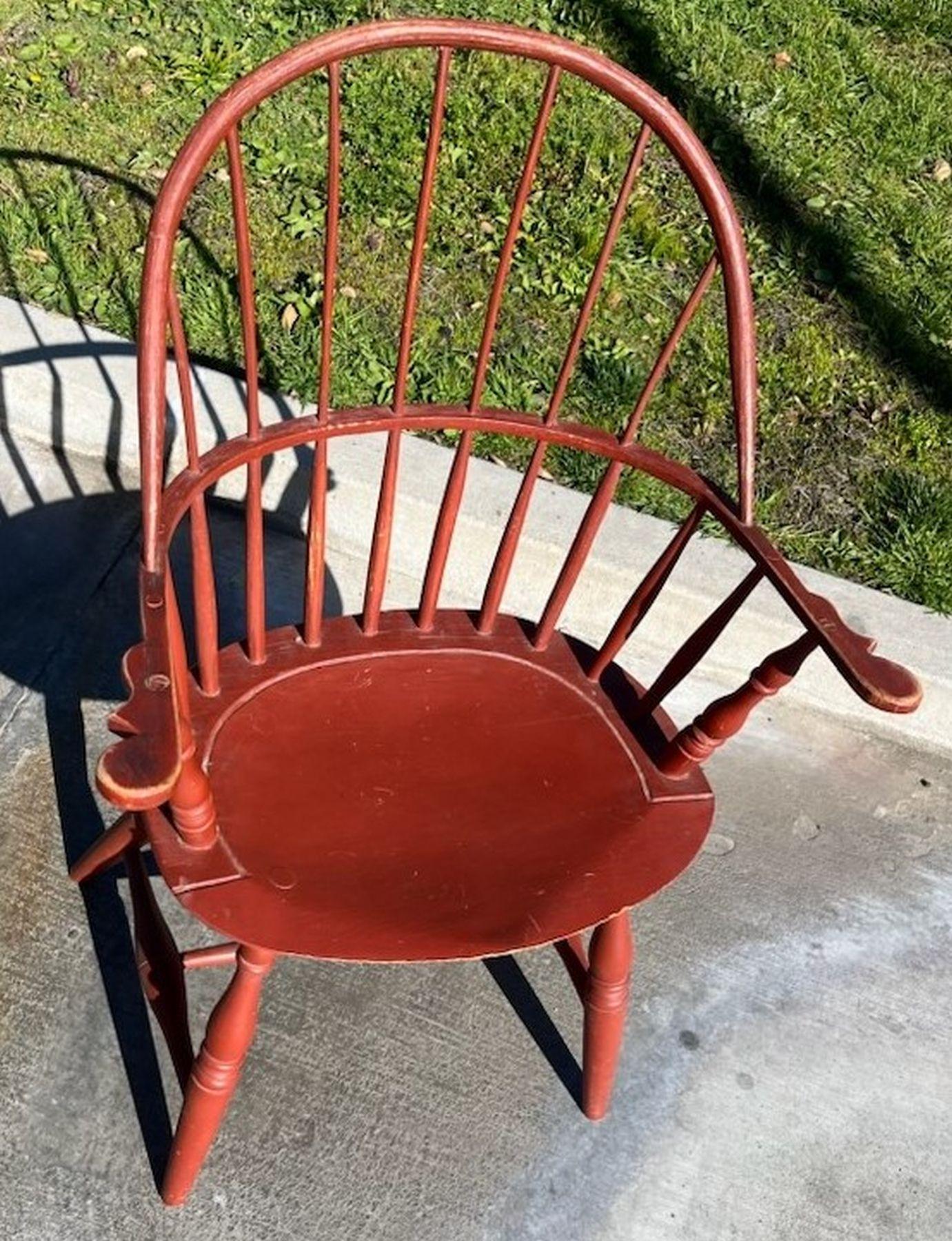 This fine red painted 19thc Windsor arm chair is in fine and sturdy condition.The later painted surface has been on there for many years and is a fun red color. This chair is very comfortable.