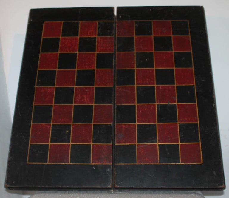 19thc original painted folding book game board in original painted surface. The red & black checker board exterior and interior. The condition is very good.