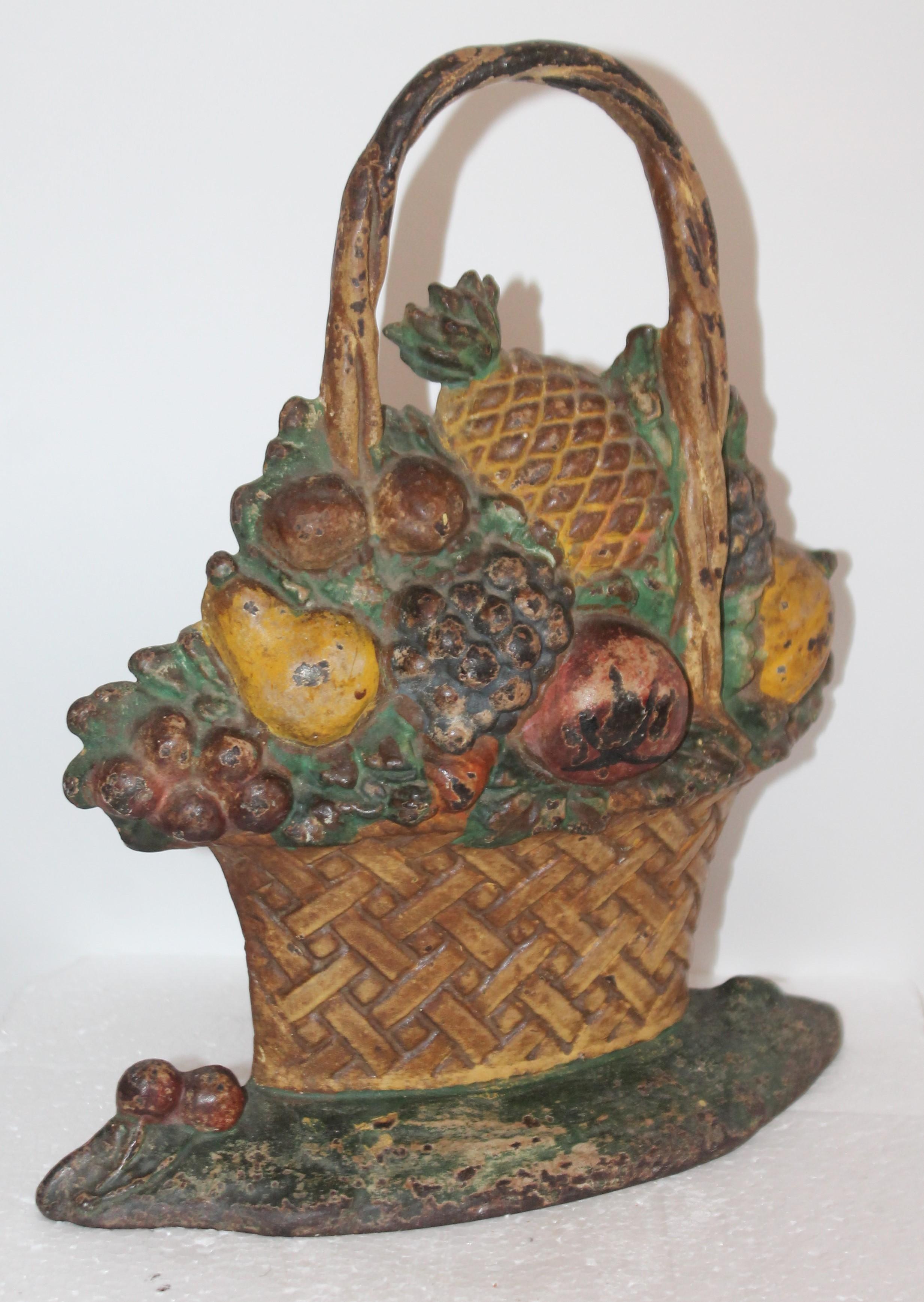 This 19th century Hubley original painted basket of fruit cast iron door stop is in fine untouched condition. So hard to find where they have not messed with the paint. Great form and super patina.
