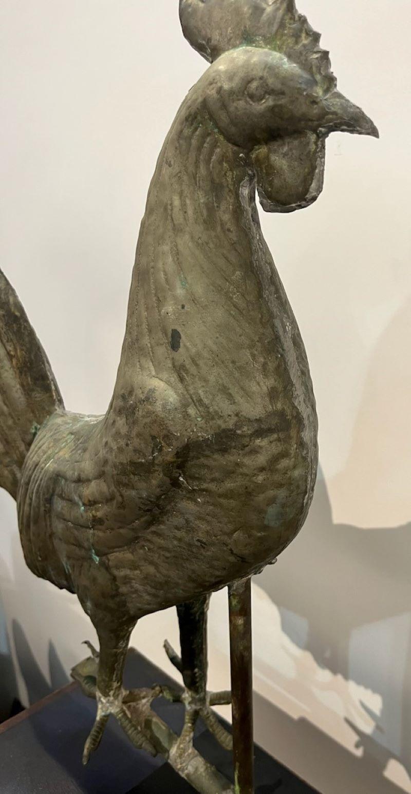 19th century full body rooster weather vane on custom iron base. This rooster has a worn and aged patina of a zinc painted surface. The copper shows through in areas as well.The weight is very good and the solder in the seems shows through. This is