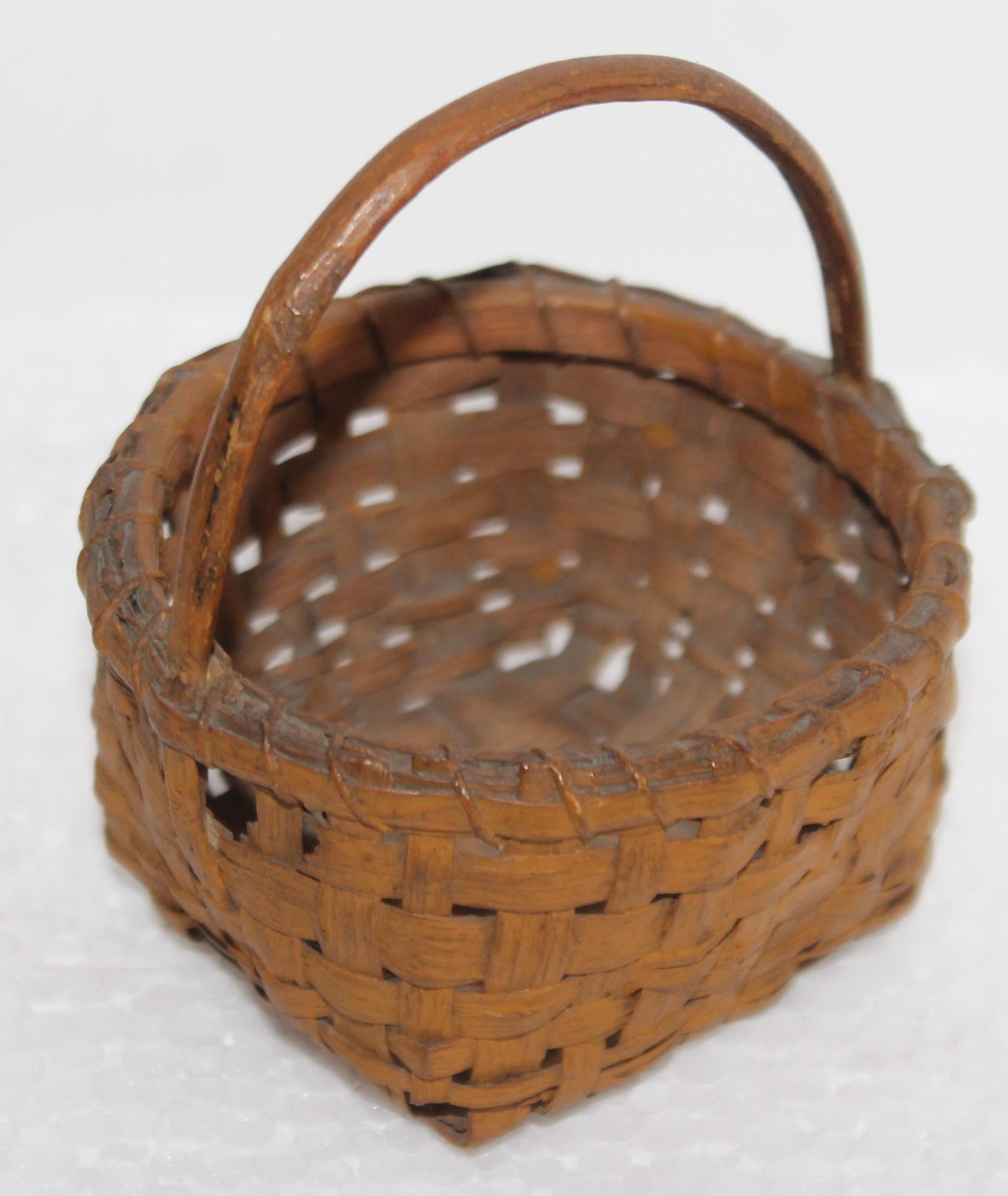 19th century miniature basket in original mustard painted surface. Minor small breaks on base or corners.