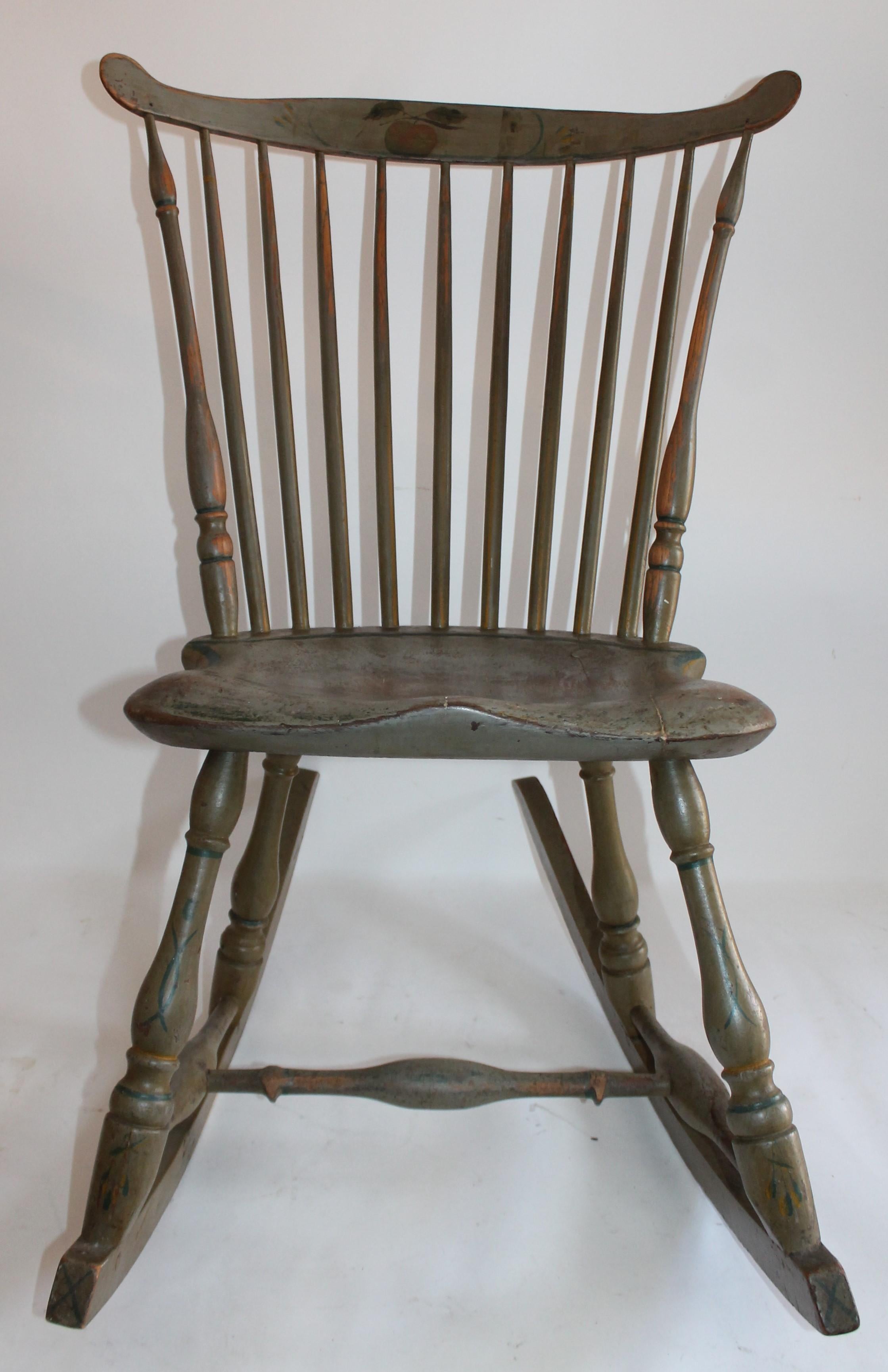 This paint decorated 19th century Pennsylvania Windsor rocking chair has great form and in good condition. The saddle seat and fiddle back has a great painted surface with an apple painted on the front. This was found in a house in Union County,