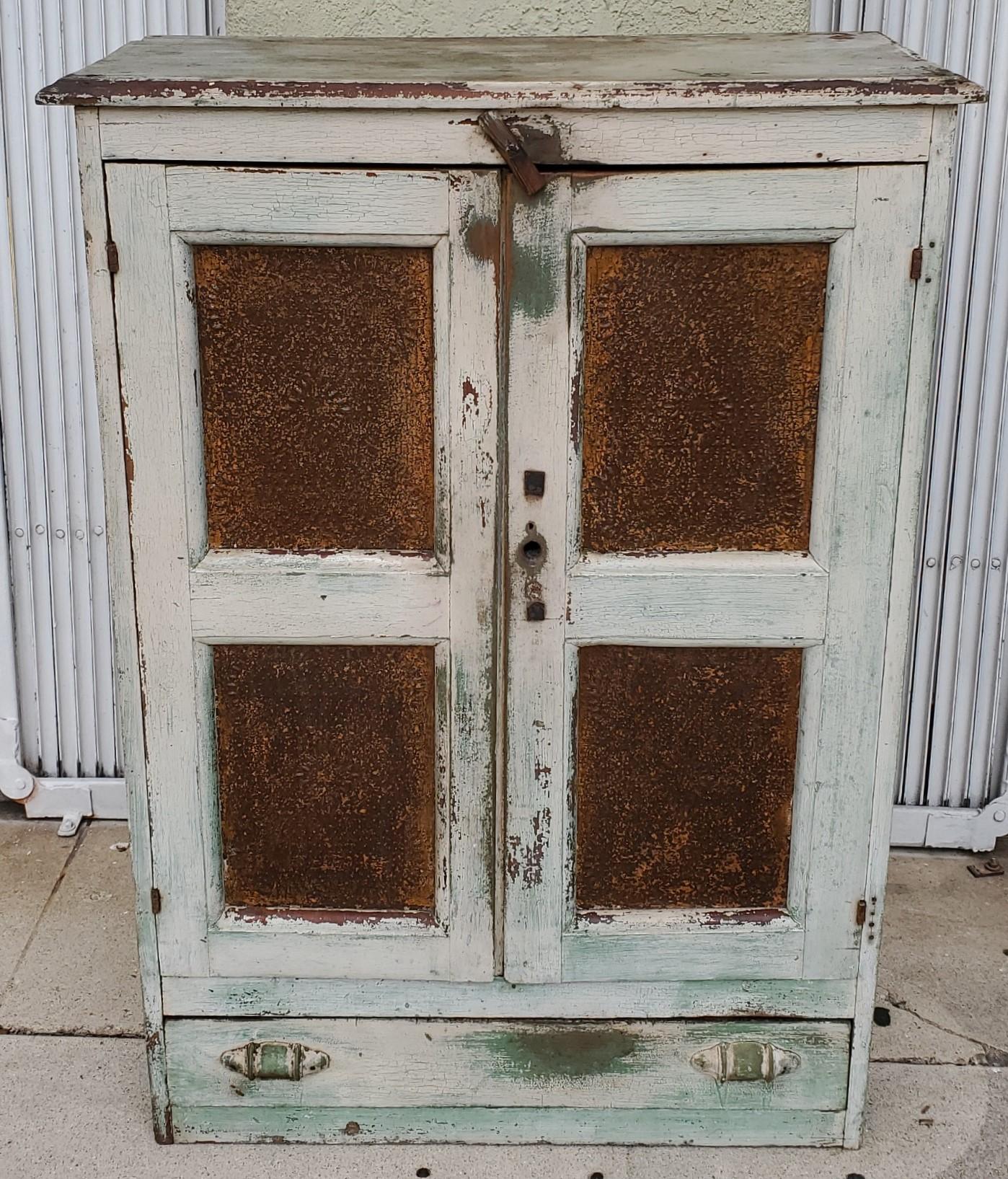 19thc original white over apple green paint and worn & aged punched tin panels. This pie safe is from East Tennessee and is in old original white painted interior as well. This pie safe came right off the farm. The condition is very good with the