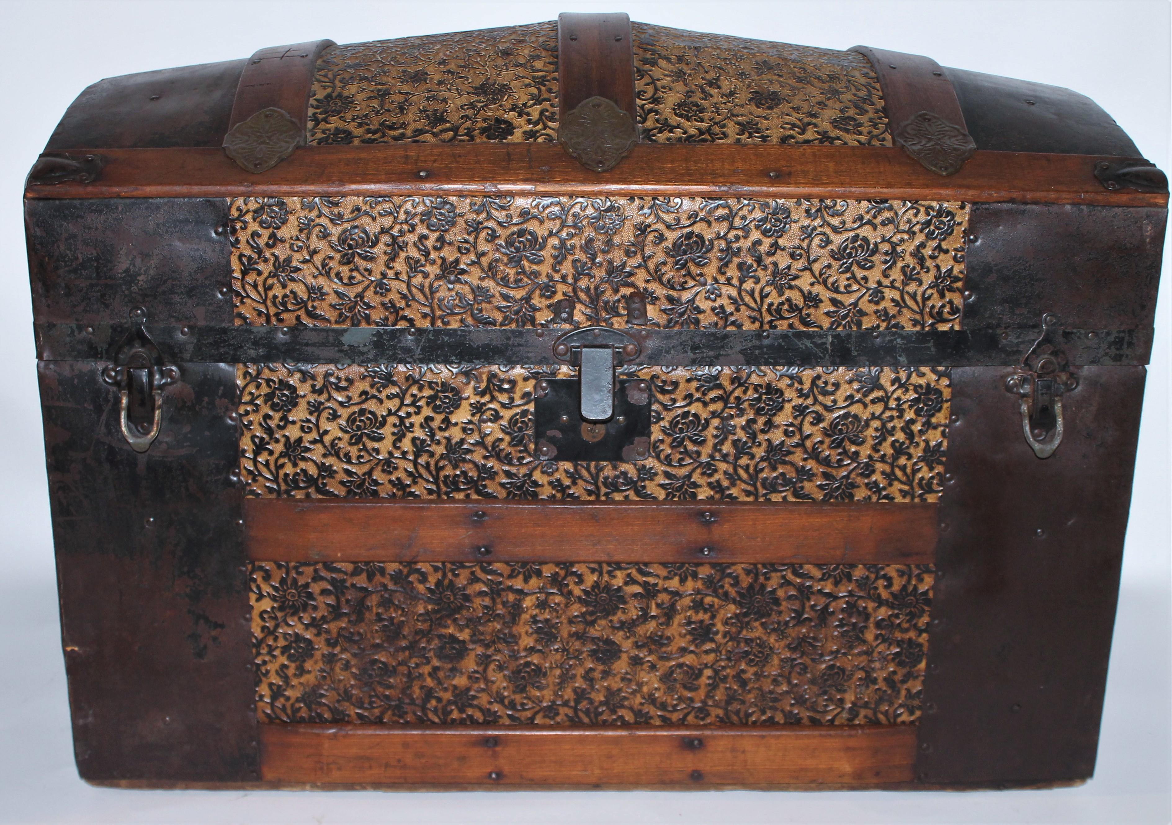 This 19th century camel back trunk or dome top trunk in fine distressed condition. The pressed tin has an original mustard painted surface. The only negative thing is the original leather handles are missing. Easy to replace with a leather belt or