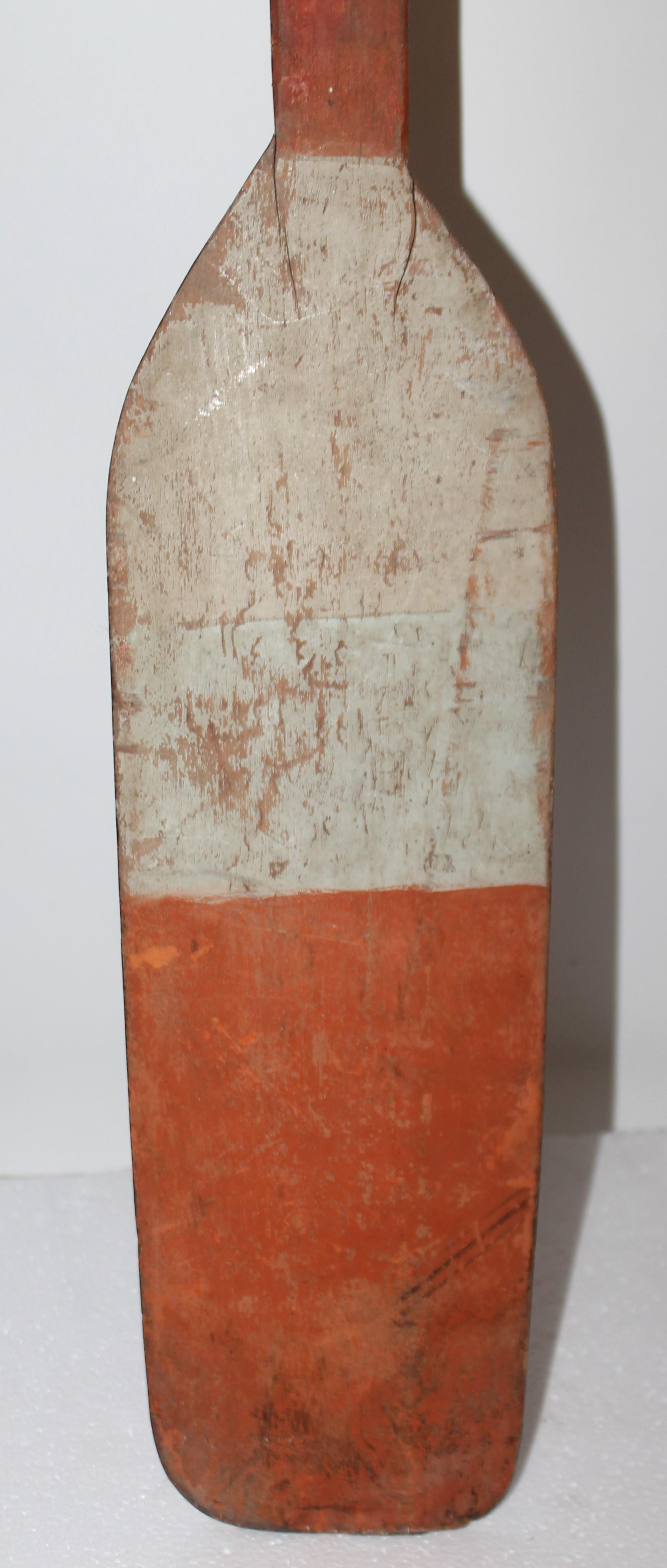 This cool 19thc orange & white painted paddle in fine condition.Great on the wall in a beach house or cottage.