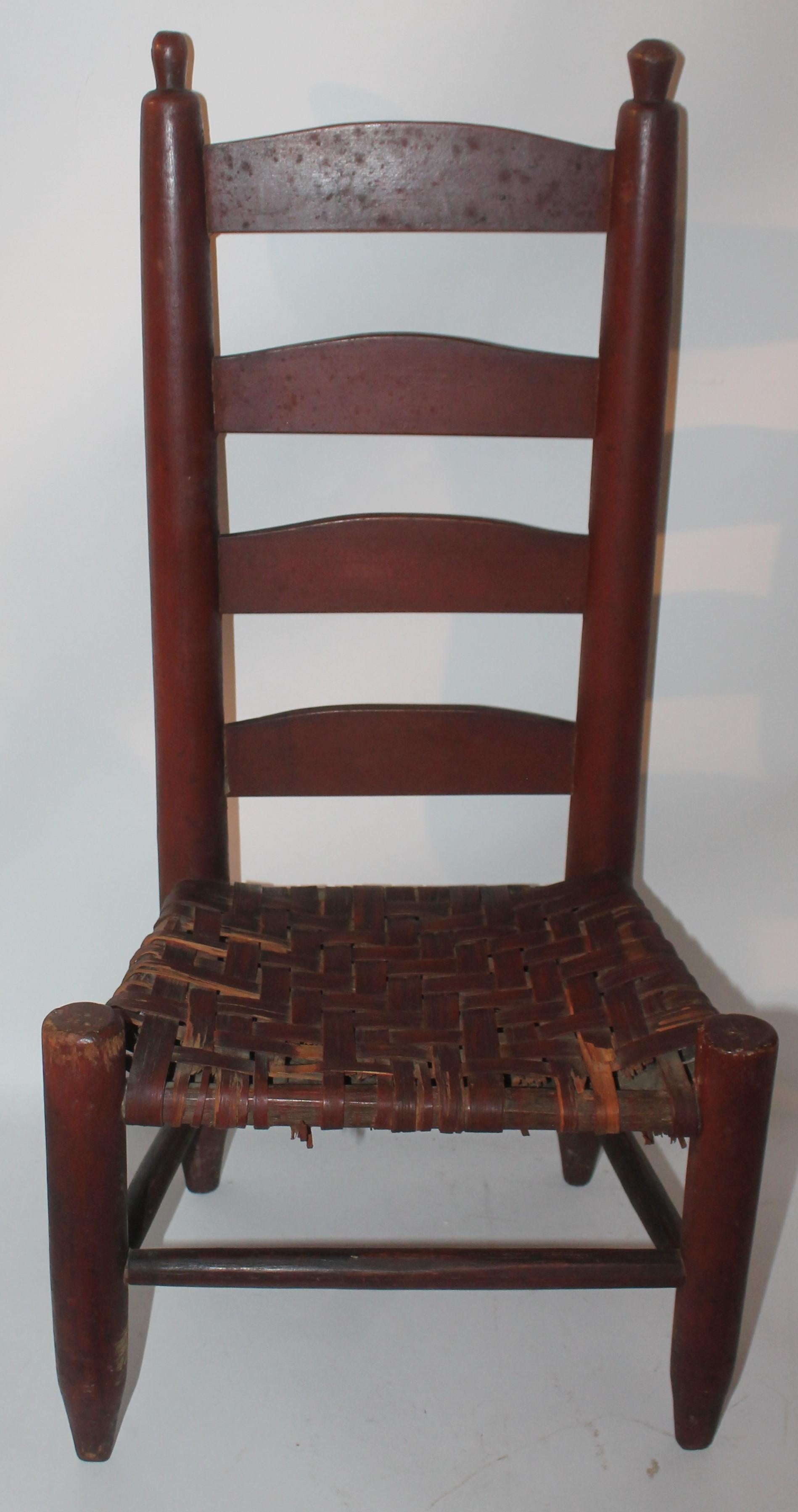 This fantastic undisturbed original red painted children's ladder back chair. The seat is a hand woven original seat.