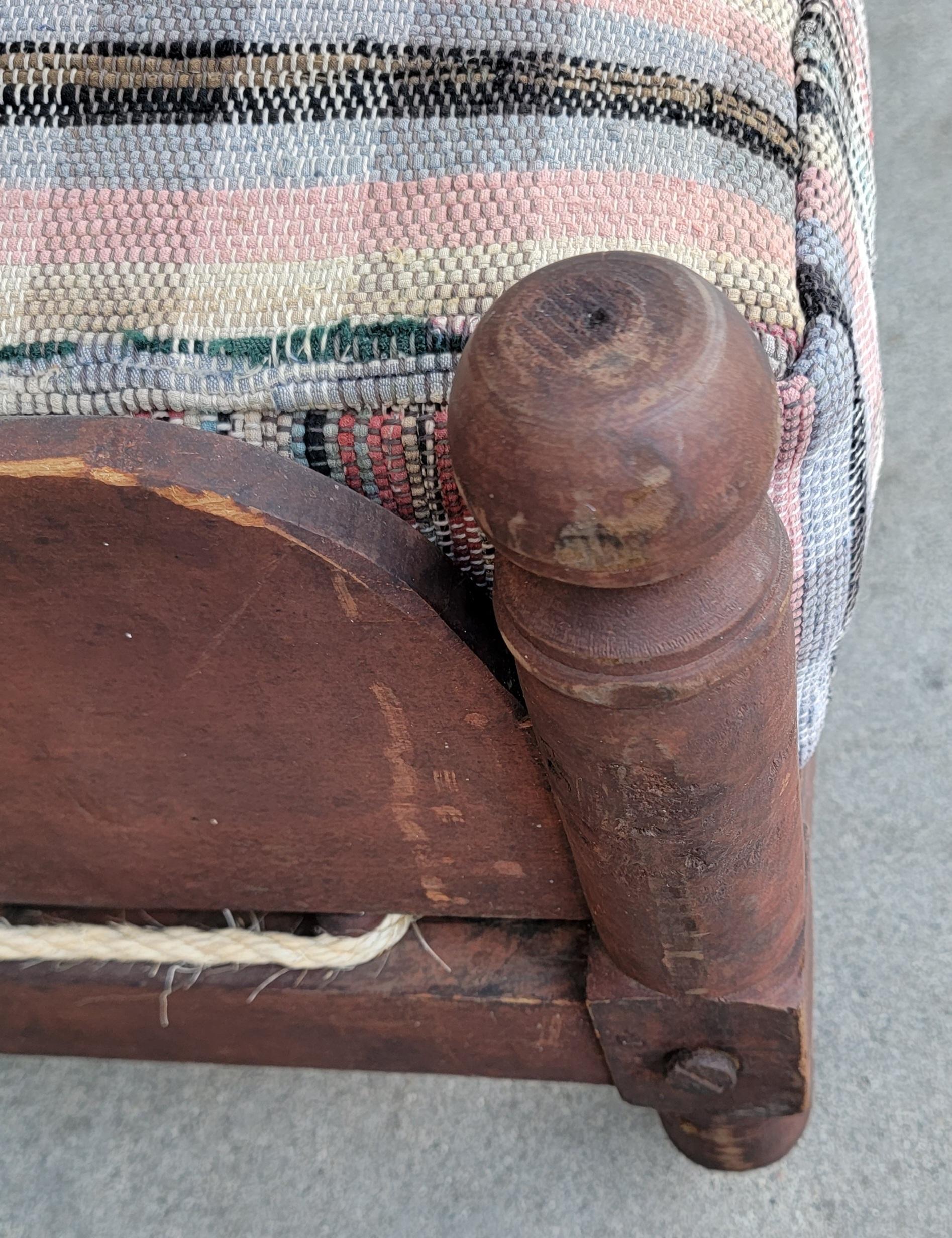 This fantastic 19thc original red painted trendle or children's rope bed is in fine condition with all the original hardware and iron casters for moving around or cleaning underneath the bed. The custom made 19thc rag rug cushion or mattress has a