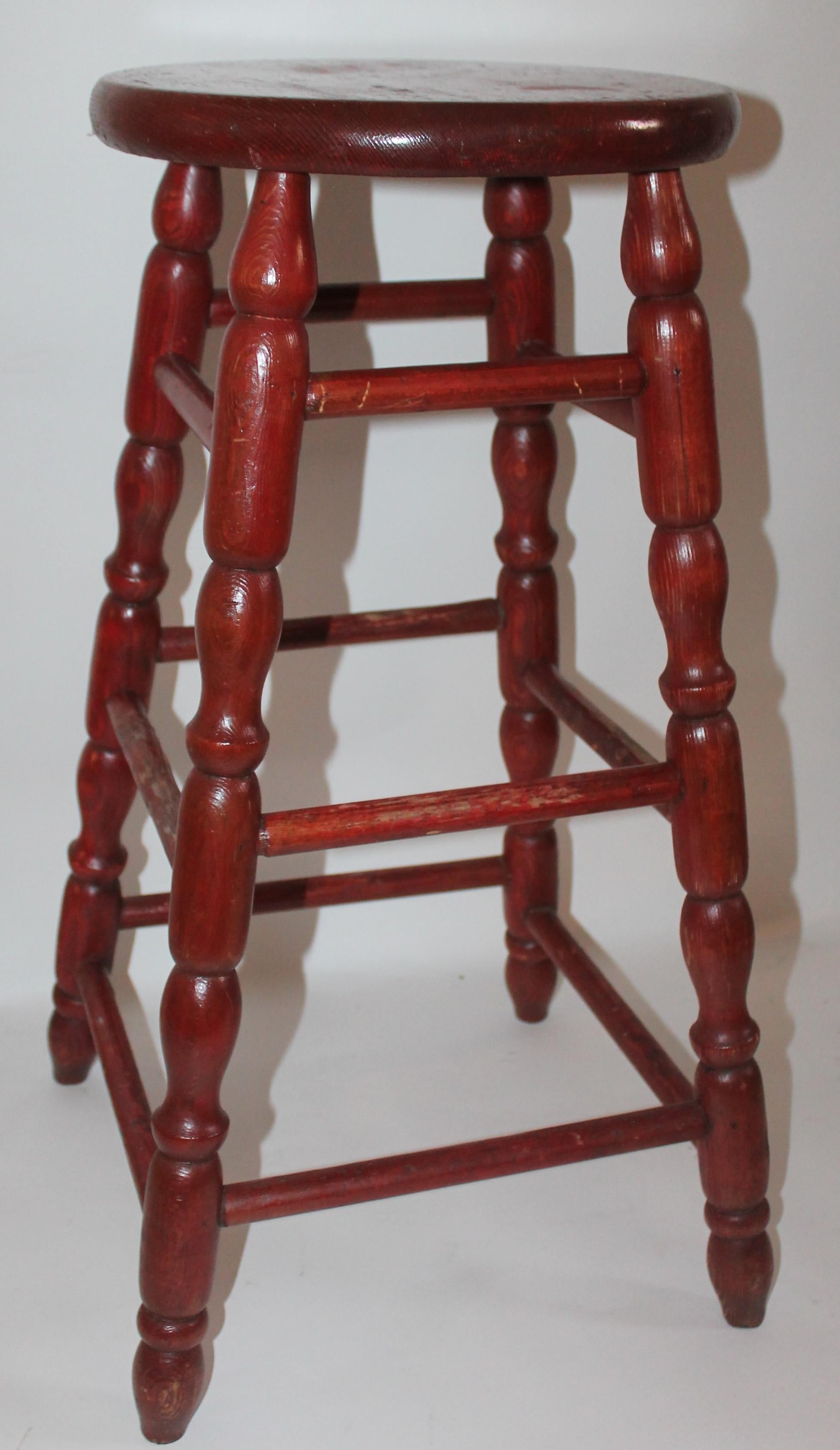 This fine and sturdy Lancaster County, Pennsylvania original red painted bar stool is in pristine condition. It has like a red stain surface. Great turned legs.