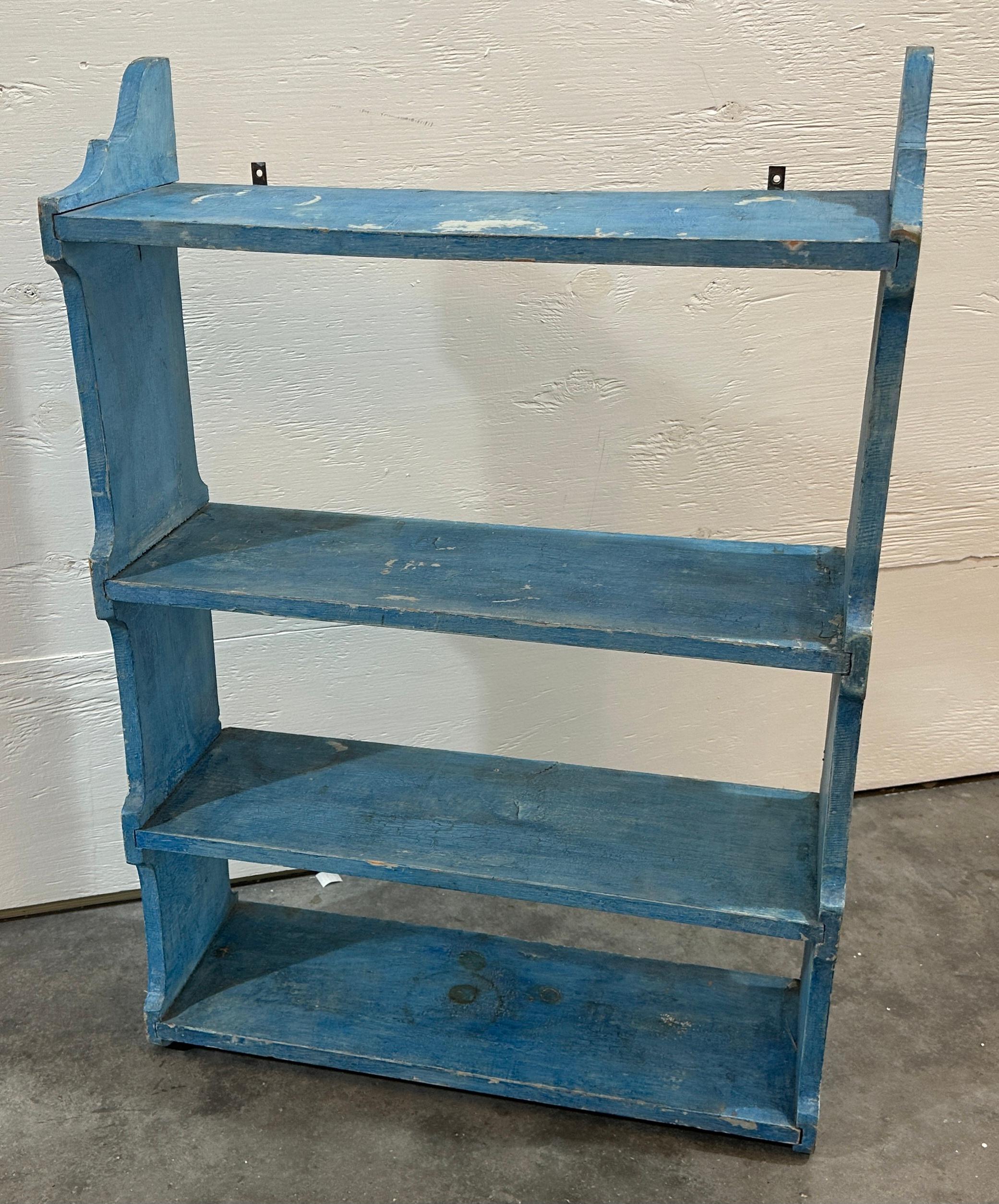 This original painted  robin egg blue painted hanging wall shelf.