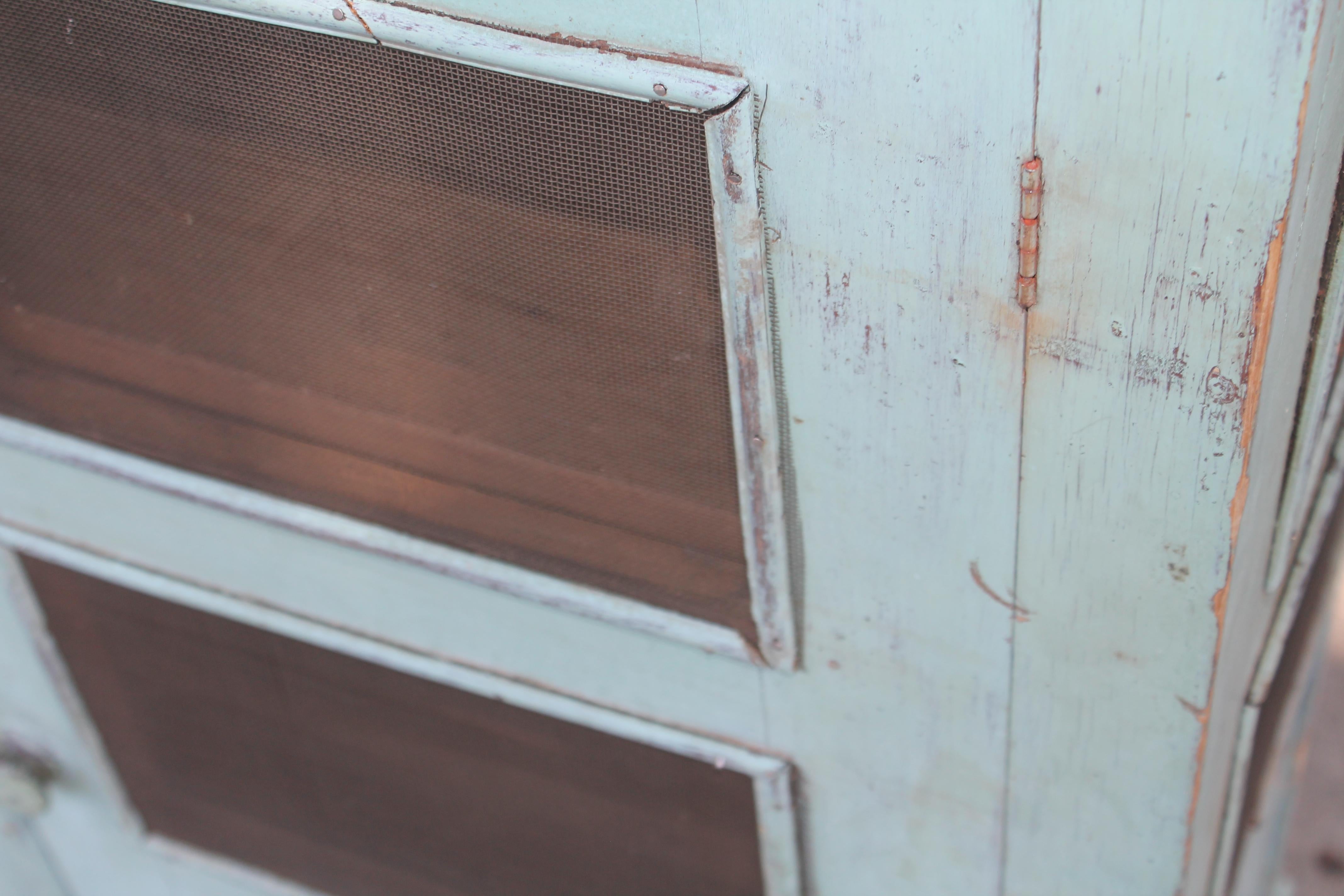 19thc original Robin egg blue painted Pies safe with two door 4 tier shelves. Amazing construction with crown top mold.