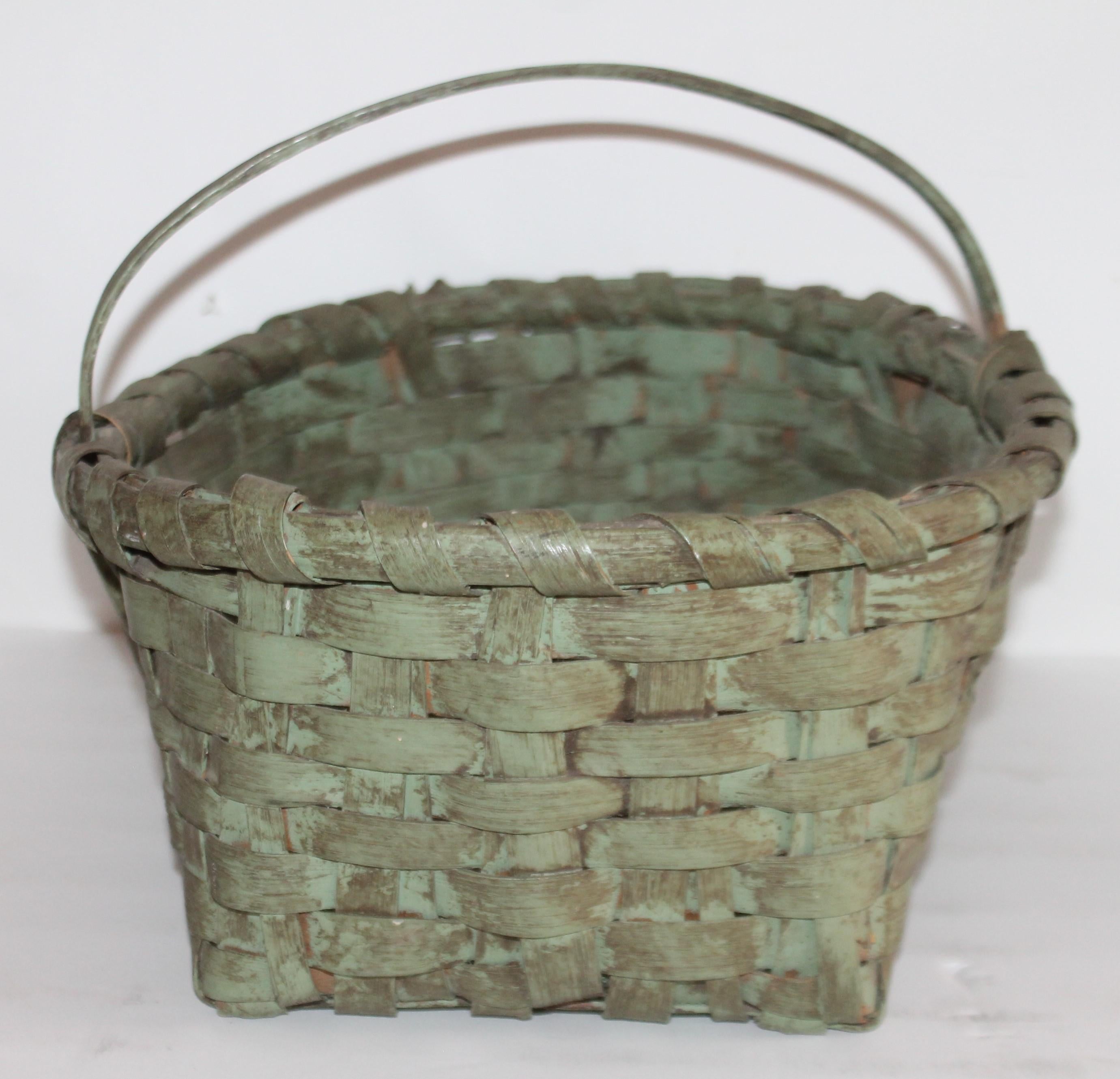 This rustic original sage green basket is in good condition. It is so rustic and has a fine aged patina surface.