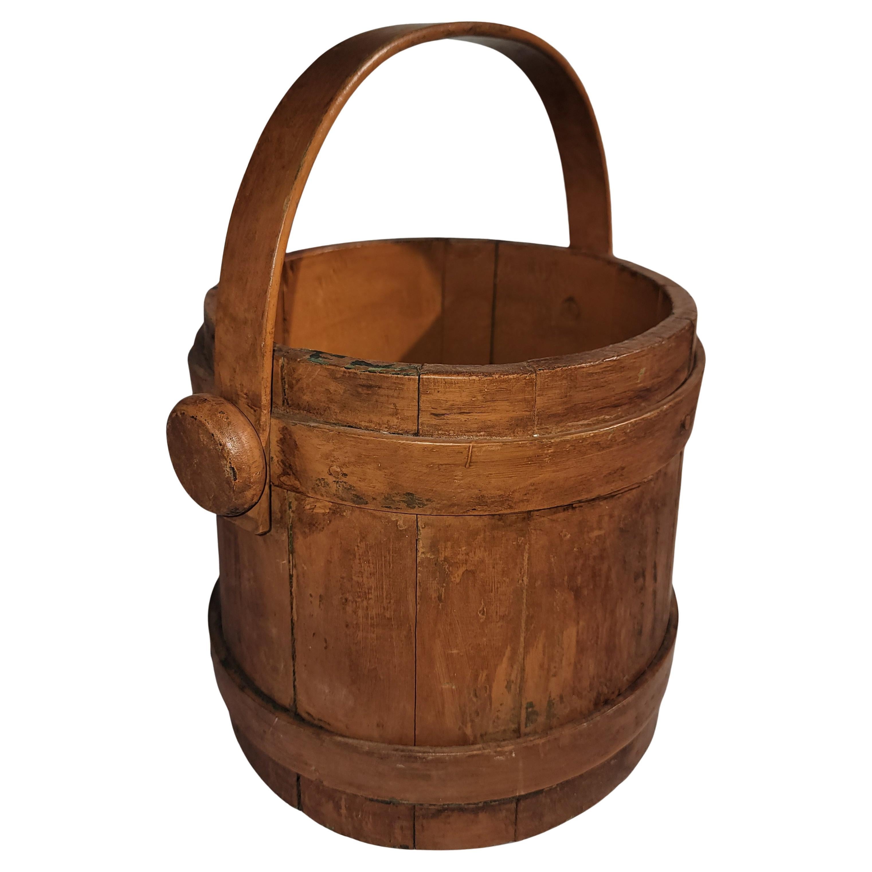 19Thc Original salmon paint over green painted base firkin or bucket with handle.The condition is fine makes for a great trash bucket in a powder room.