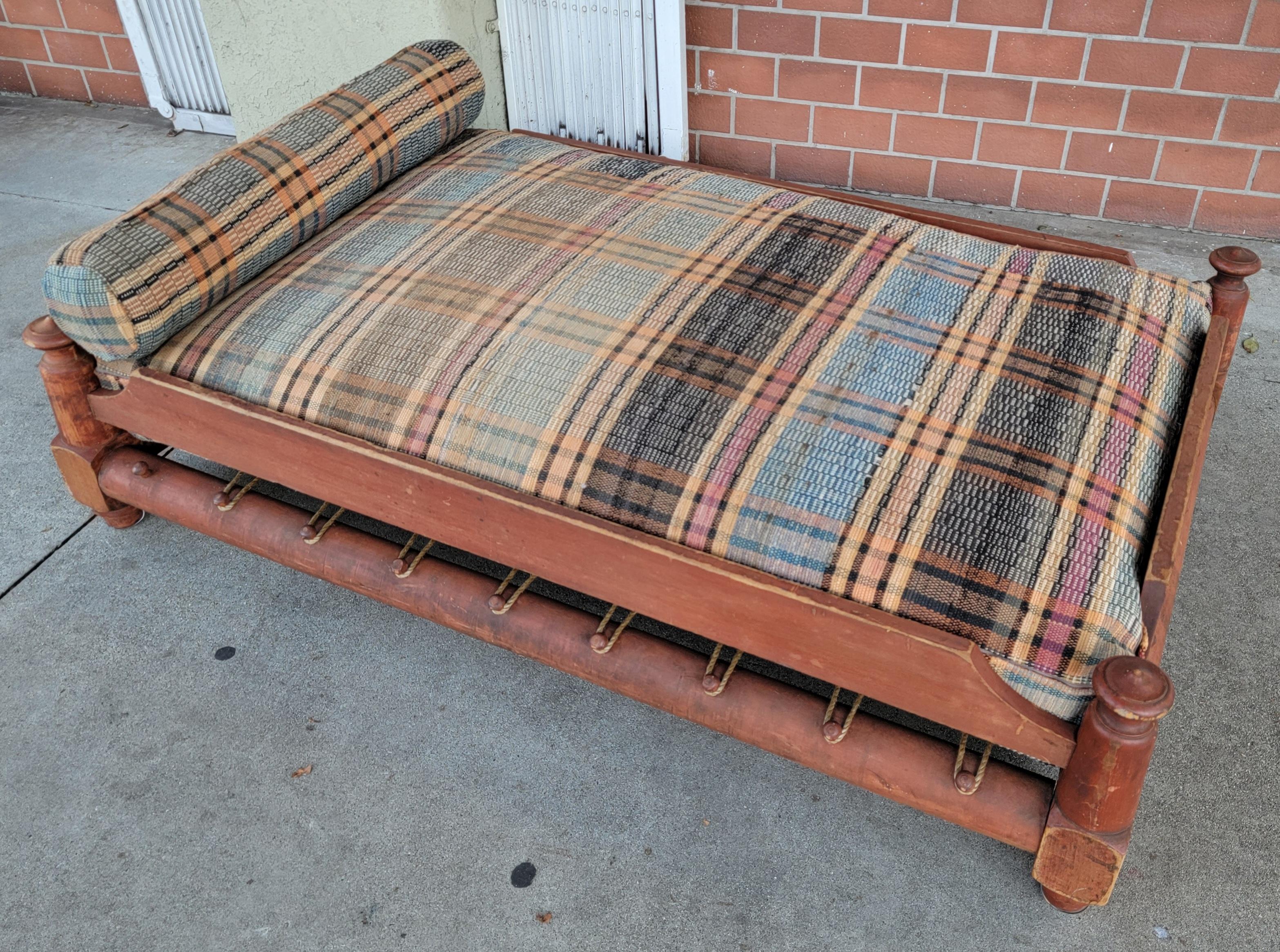 19thc original salmon painted trendle or child's rope bed with a custom made mattress from 19thc rag rug fabric. It comes with rag rug cushions & pillows. This bed is in amazing condition.