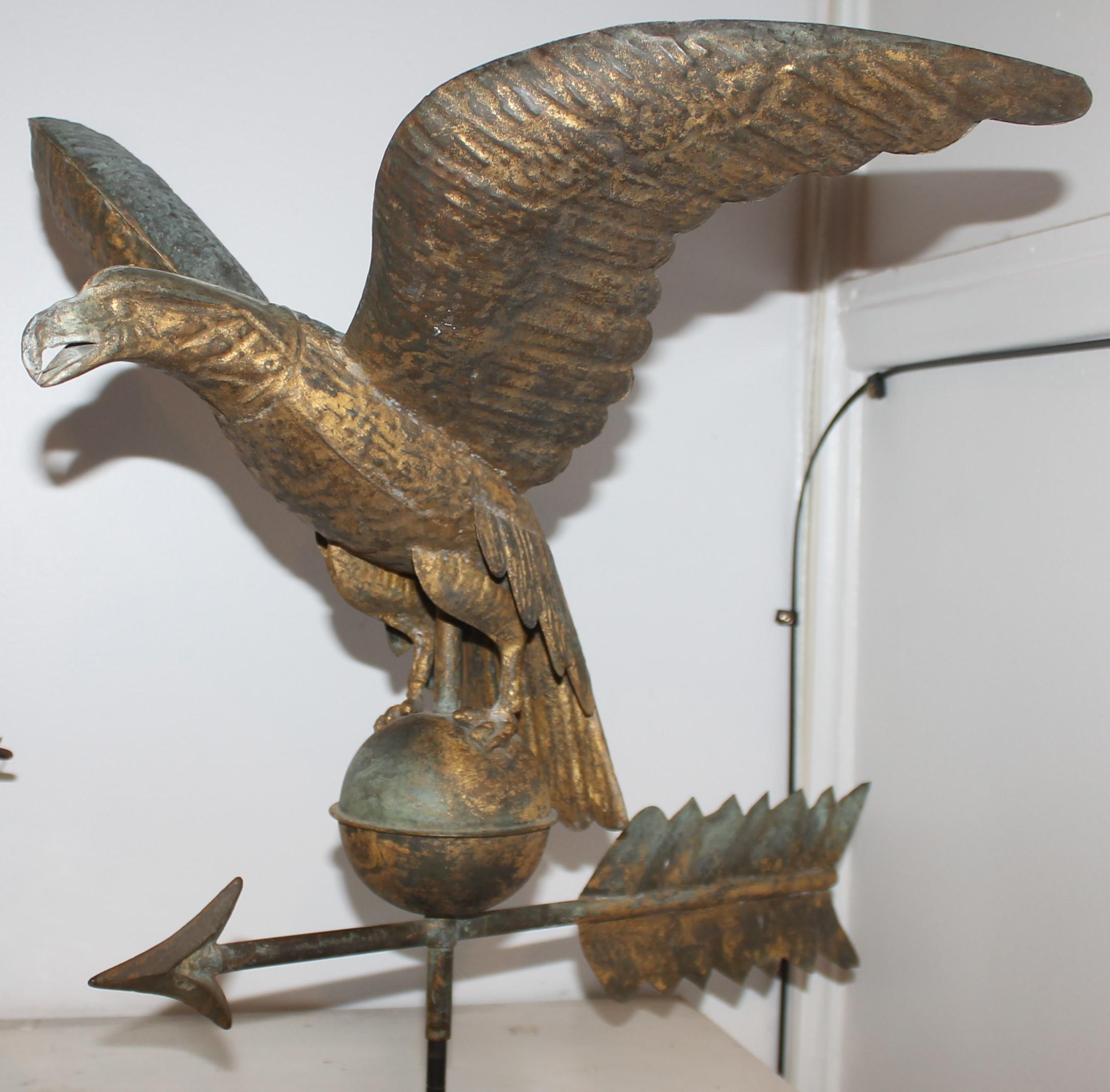 19th C original gilded surface full body eagle weather vane with the best undisturbed surface.The base is custom made iron stand.This eagle is attributed to Harris & Company.