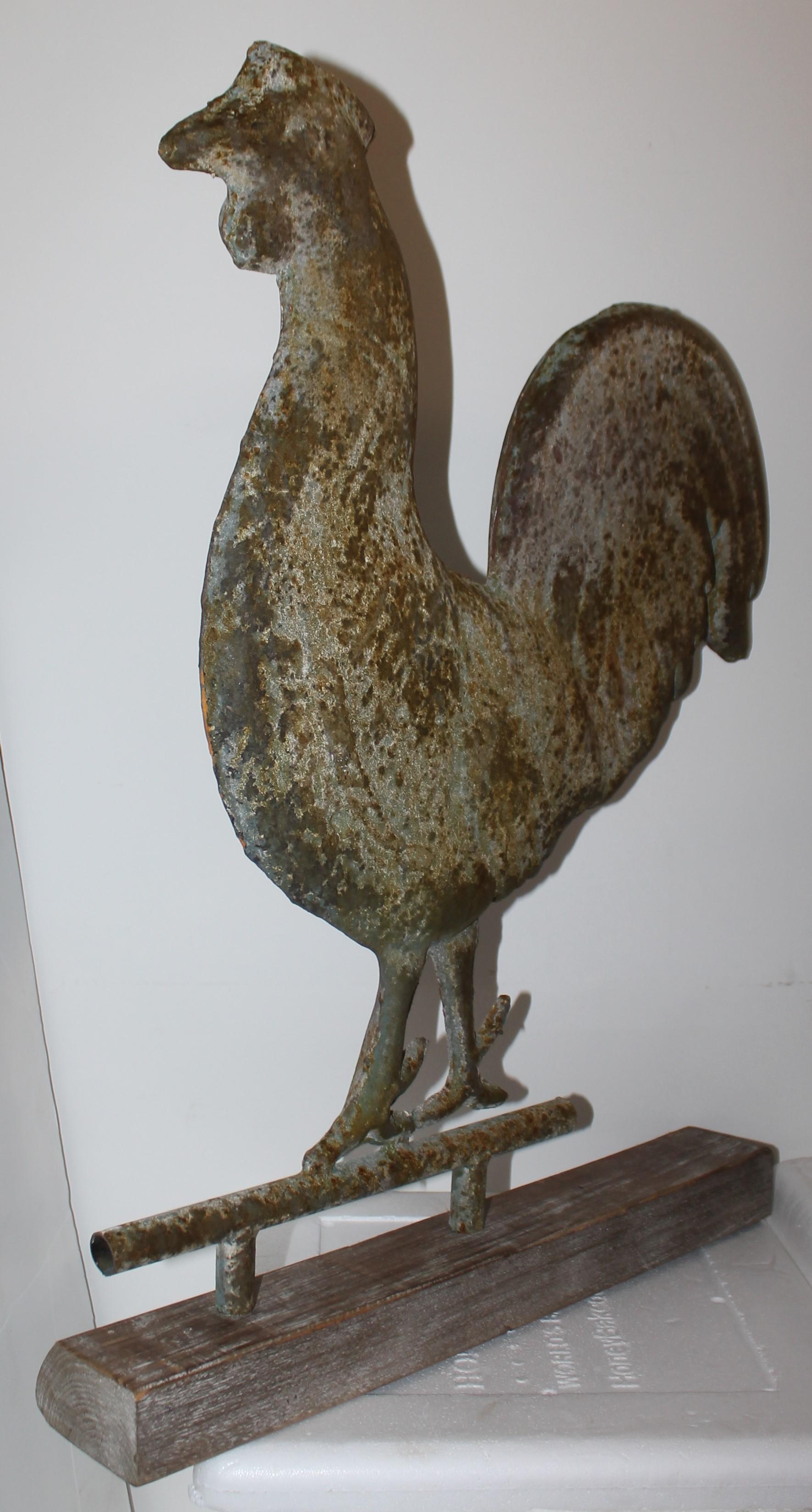This amazing patinated rooster weather vane is in fantastic as found condition. Was found in New England and is in undisturbed surface. It is on a aged plank of wood as found from the folk art collection. It came from a fifty year old folk art and