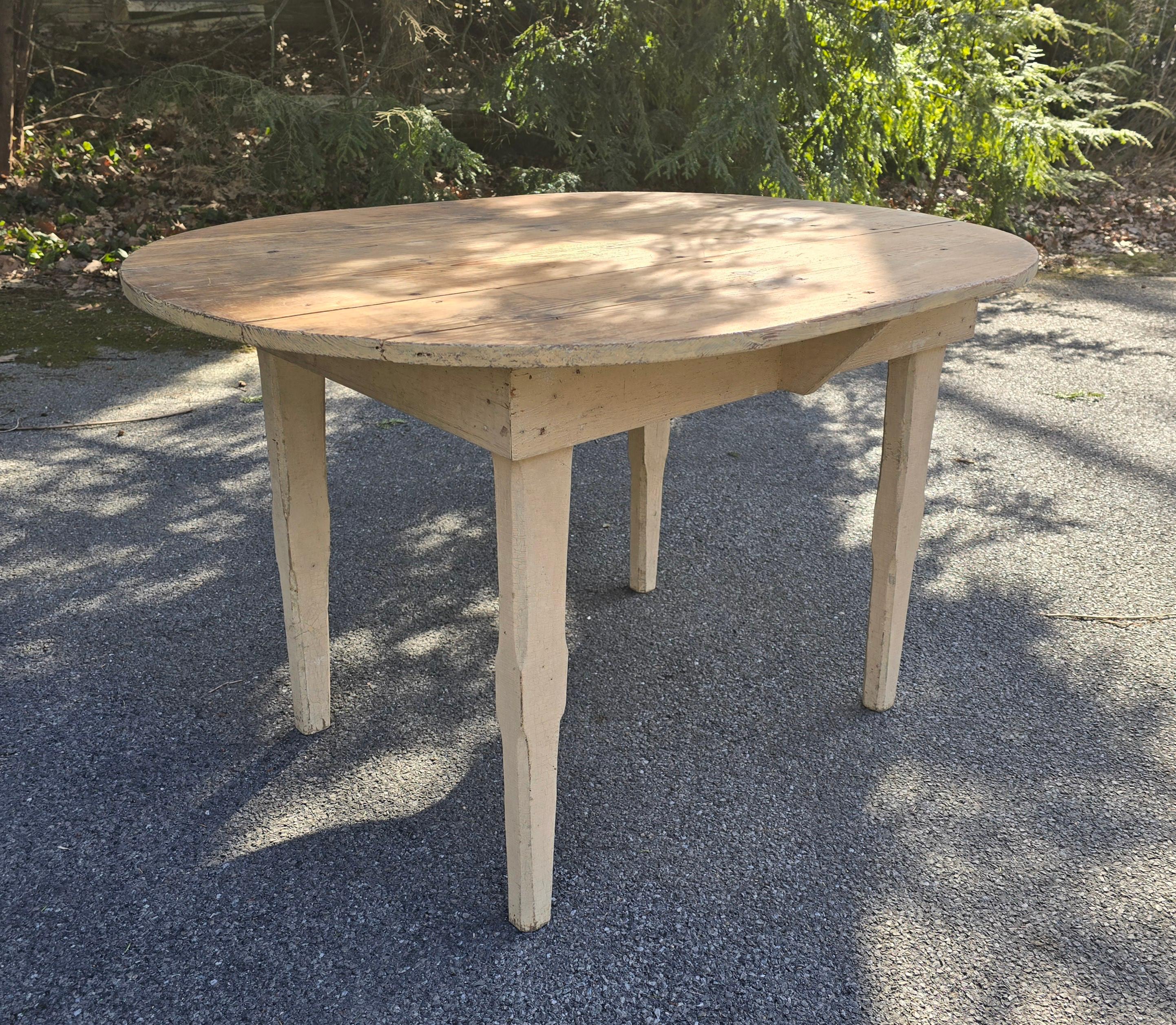 36 x 48 x 29 high. 
Eastern shore ca 1890. Very mint.
19thc rare and unusual oval, in original white paint, farm table with tapered legs Square cut nails. Wonderful original white painted surface.