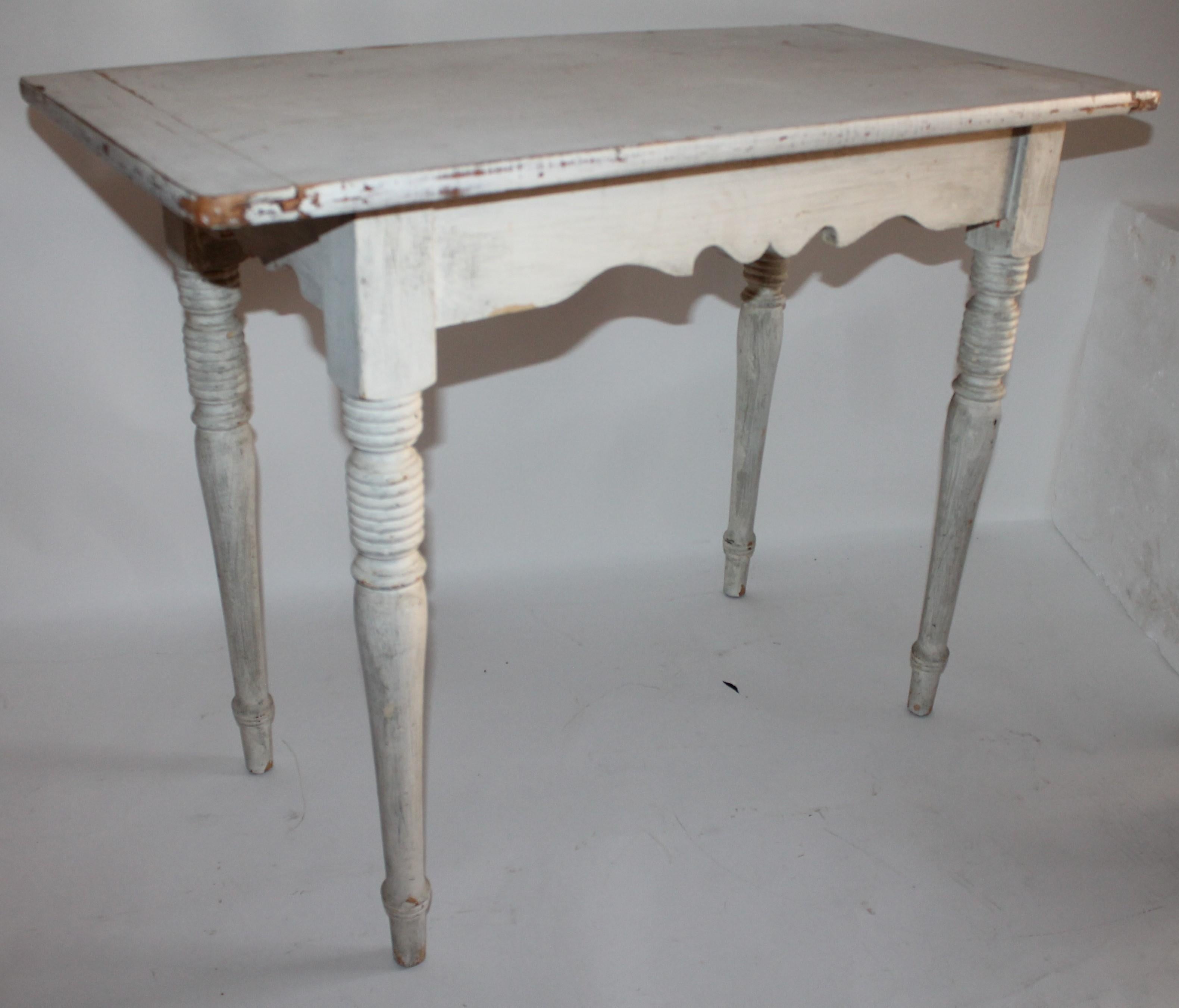 This fine 19th century country side table has nice turned legs and a great scalloped skirt. The top is constructed with breadboard ends and fantastic aged patina.