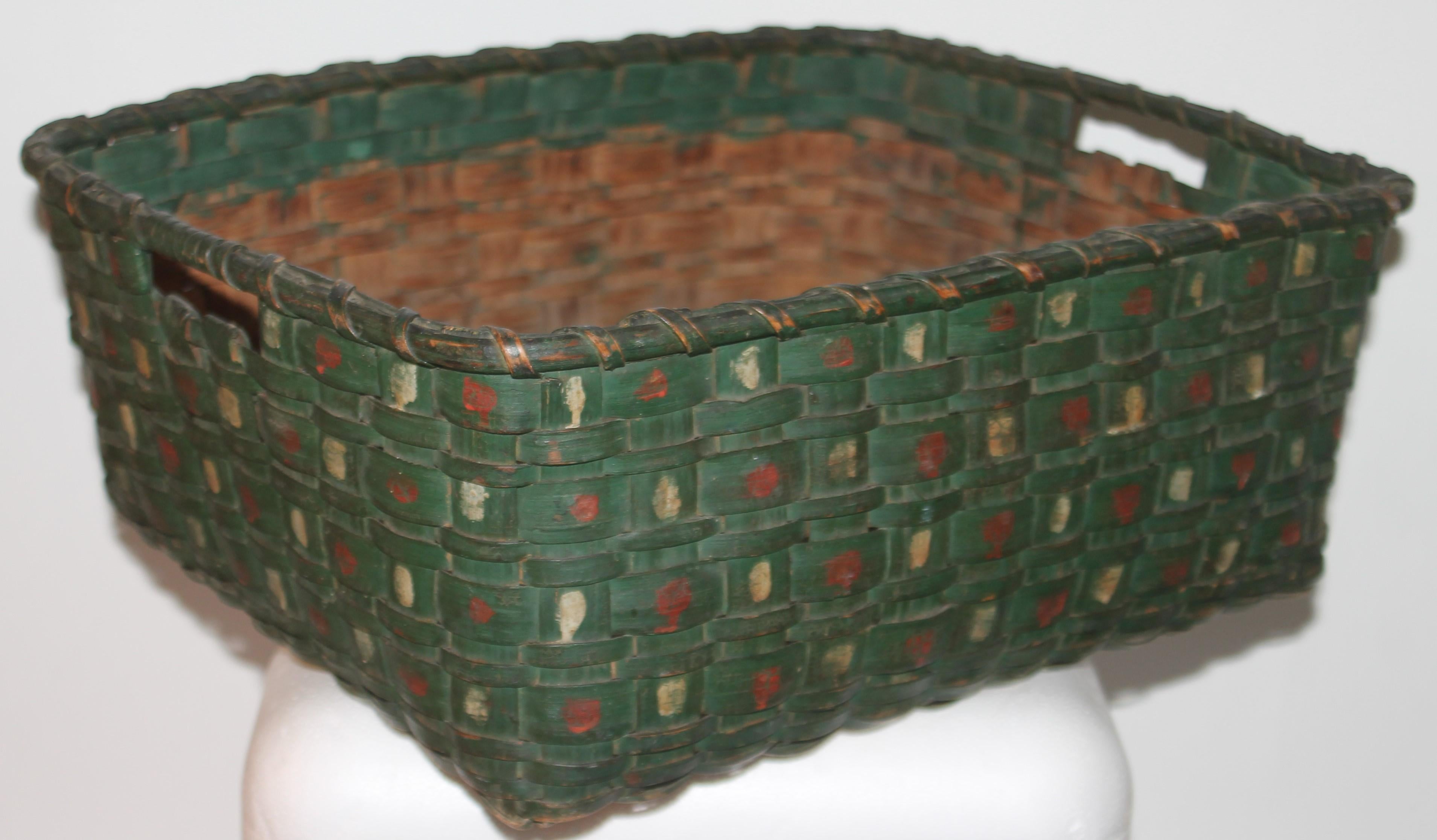 This fine amazing undisturbed paint decorated basket has the original poke a dot original painted decoration on a green painted surface.Fantastic condition and a nice mellow unpainted bottom and interior. Fantastic collectors piece.