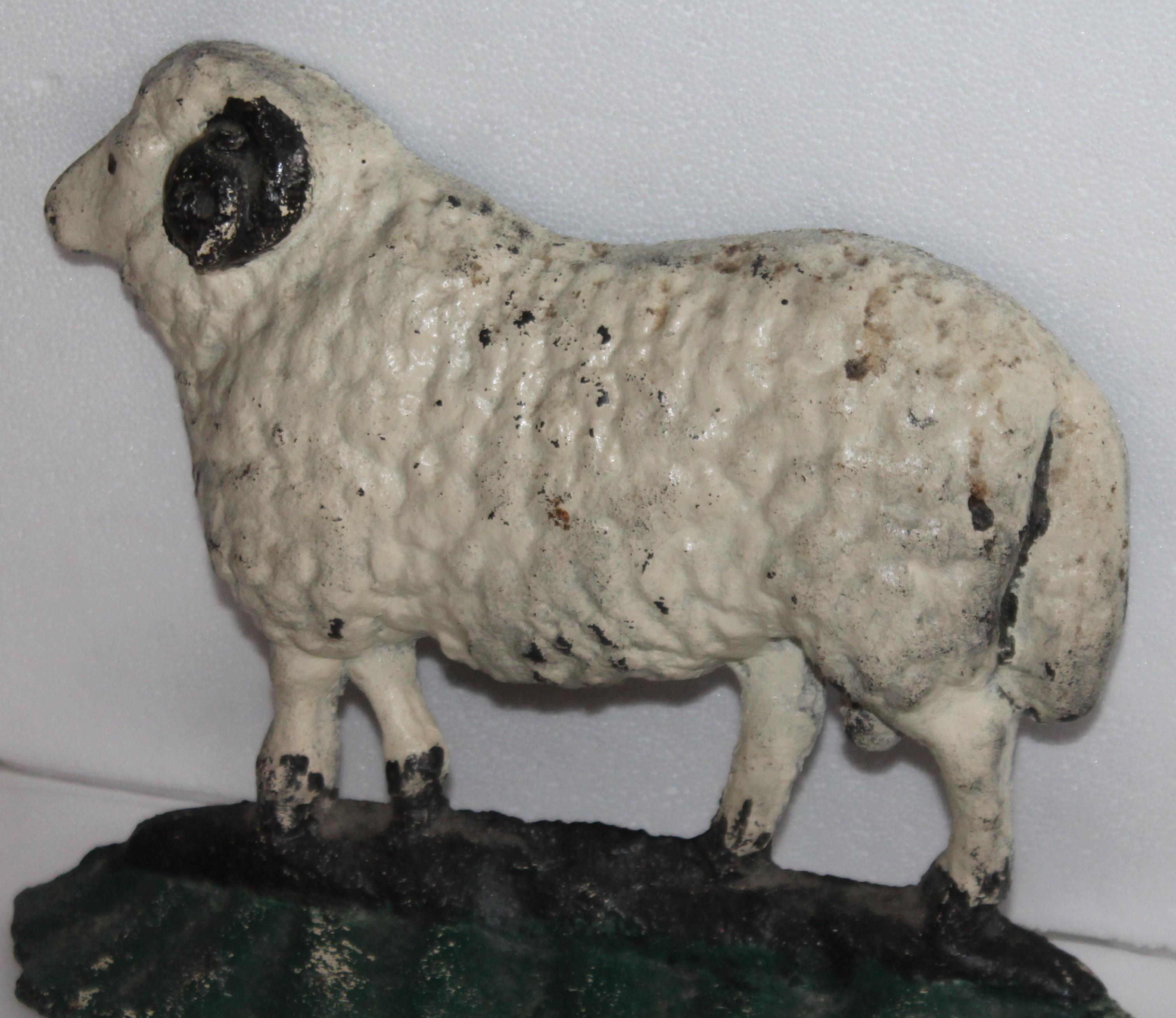 This fun and heavy cast iron lamb painted door stop is in great condition and is very heavy. This is second coat paint but old paint.