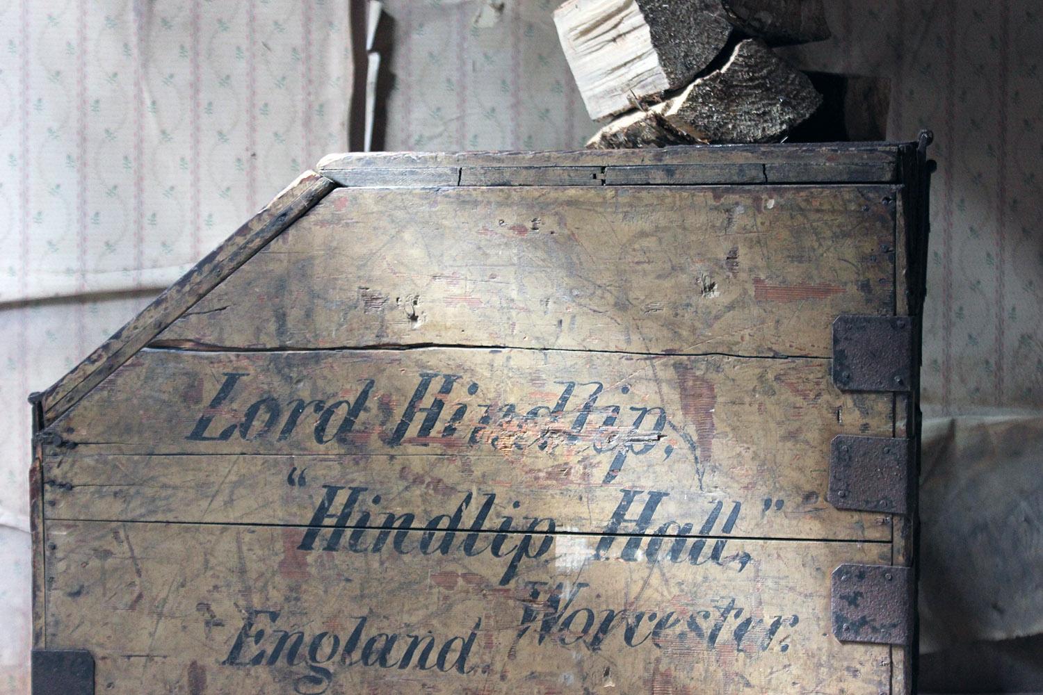 The rectangular sandy sage green painted pine storage or Campaign type carrying luggage trunk, having a hinged double-hatched sloping lid revealing a vacant interior, one flank being beautifully sign-written ‘Lord Hindlip, Hindlip Hall, Worcester,
