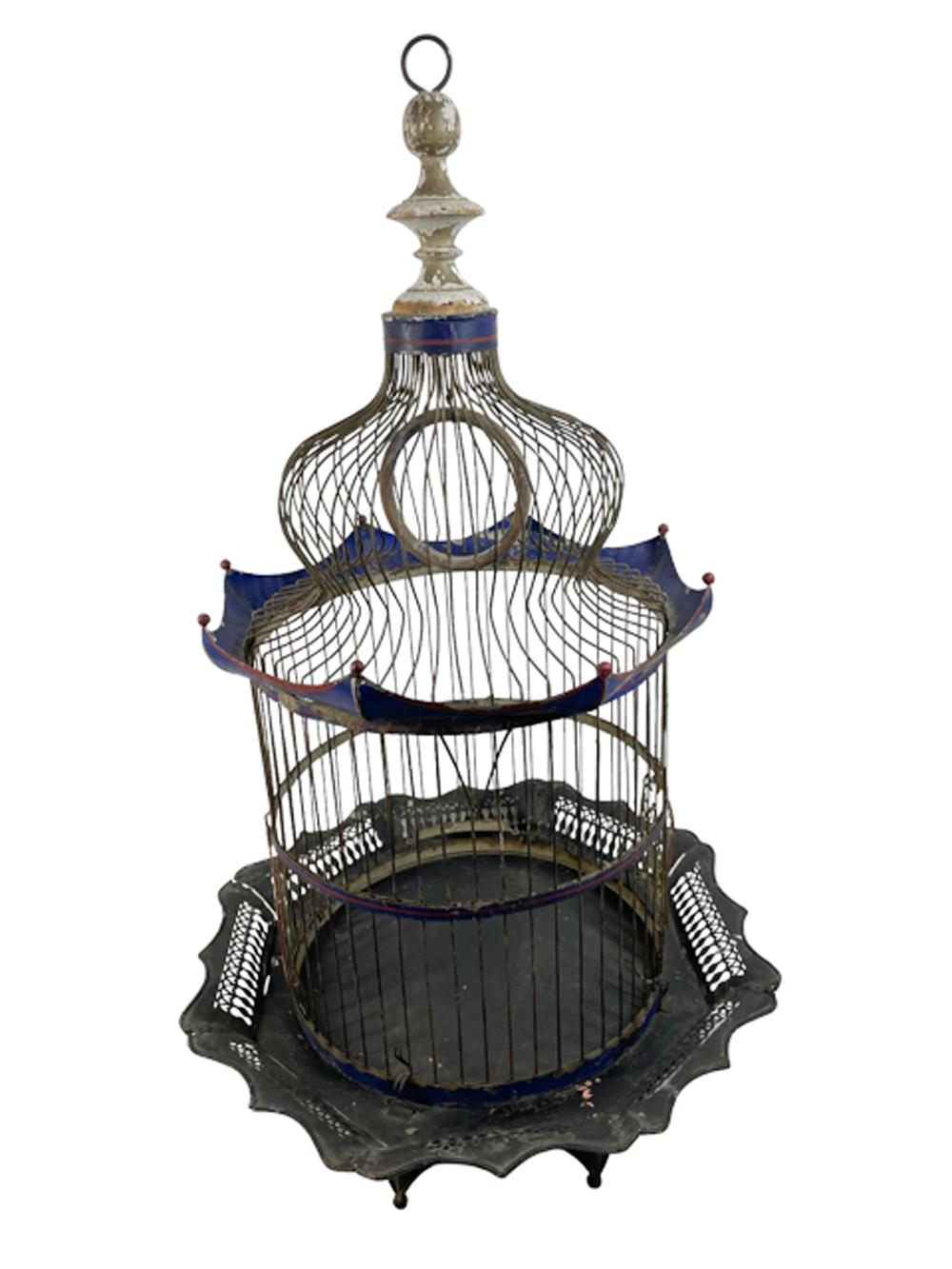 Nineteenth century American Birdcage in the Orientalist style. The wire bars with tin hoops at base, center, and top forming cylindrical cage, two cast zinc doors inscribed 'J. MAXHEIMER'S / PATENT JUNE 3 1882 NY' at bottom, a scalloped cornice