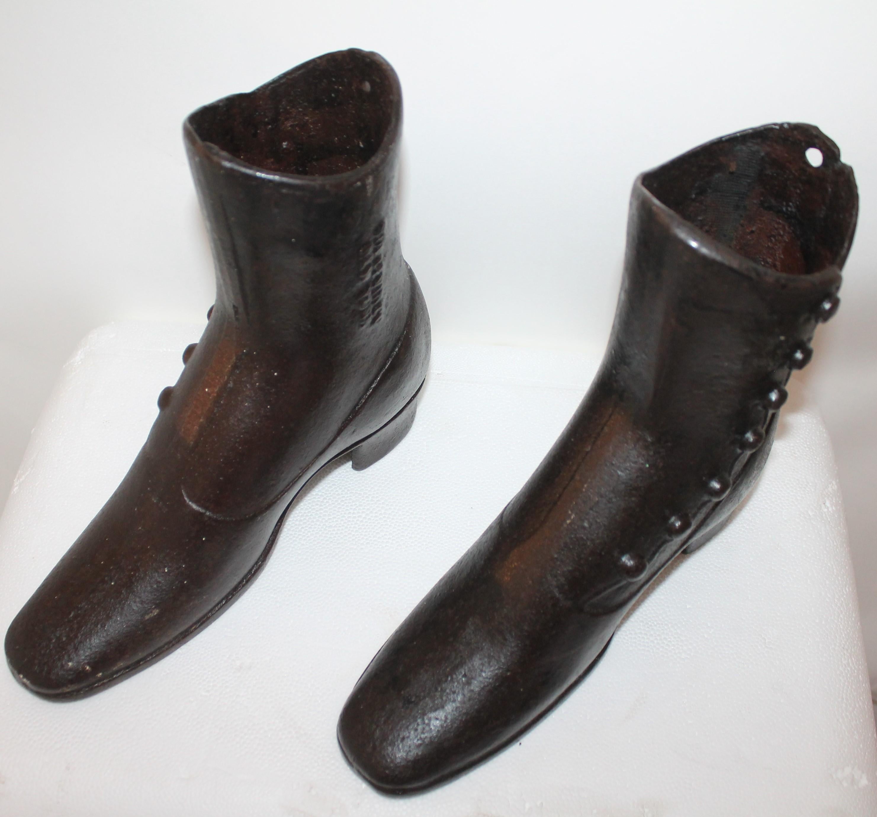 These 19th century cast iron boots are in good condition and are signed SOL LEVIN CO. NEW YORK on both boots embossed on the side of the boots. Thesee boots could also be used as door stops !