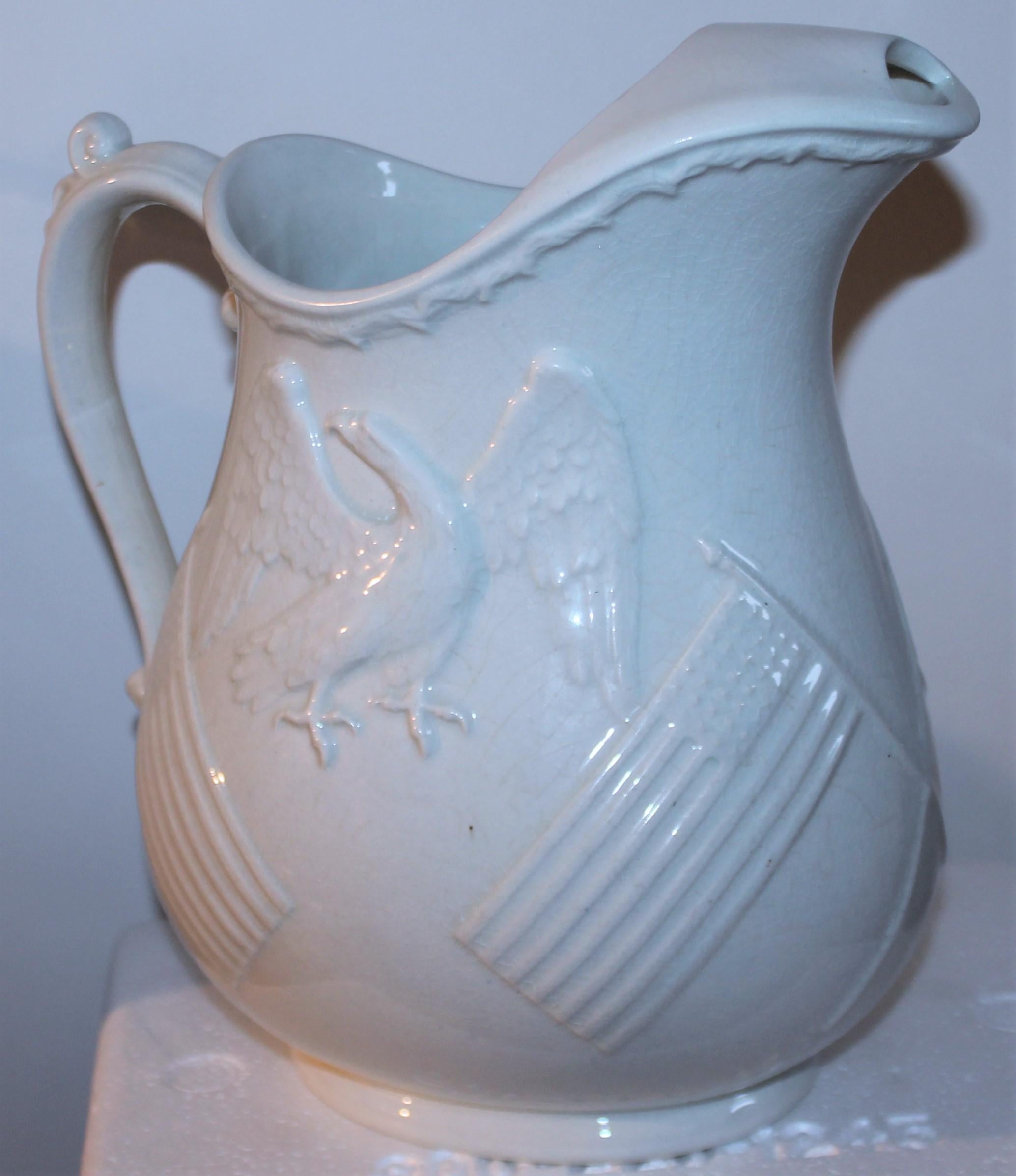 This amazing mid 19thc bright white ironstone water pitcher has embossed American flags & eagle on both sides of the pitcher. This amazing and folky folk art & patriotic pitcher has been prof cleaned too.