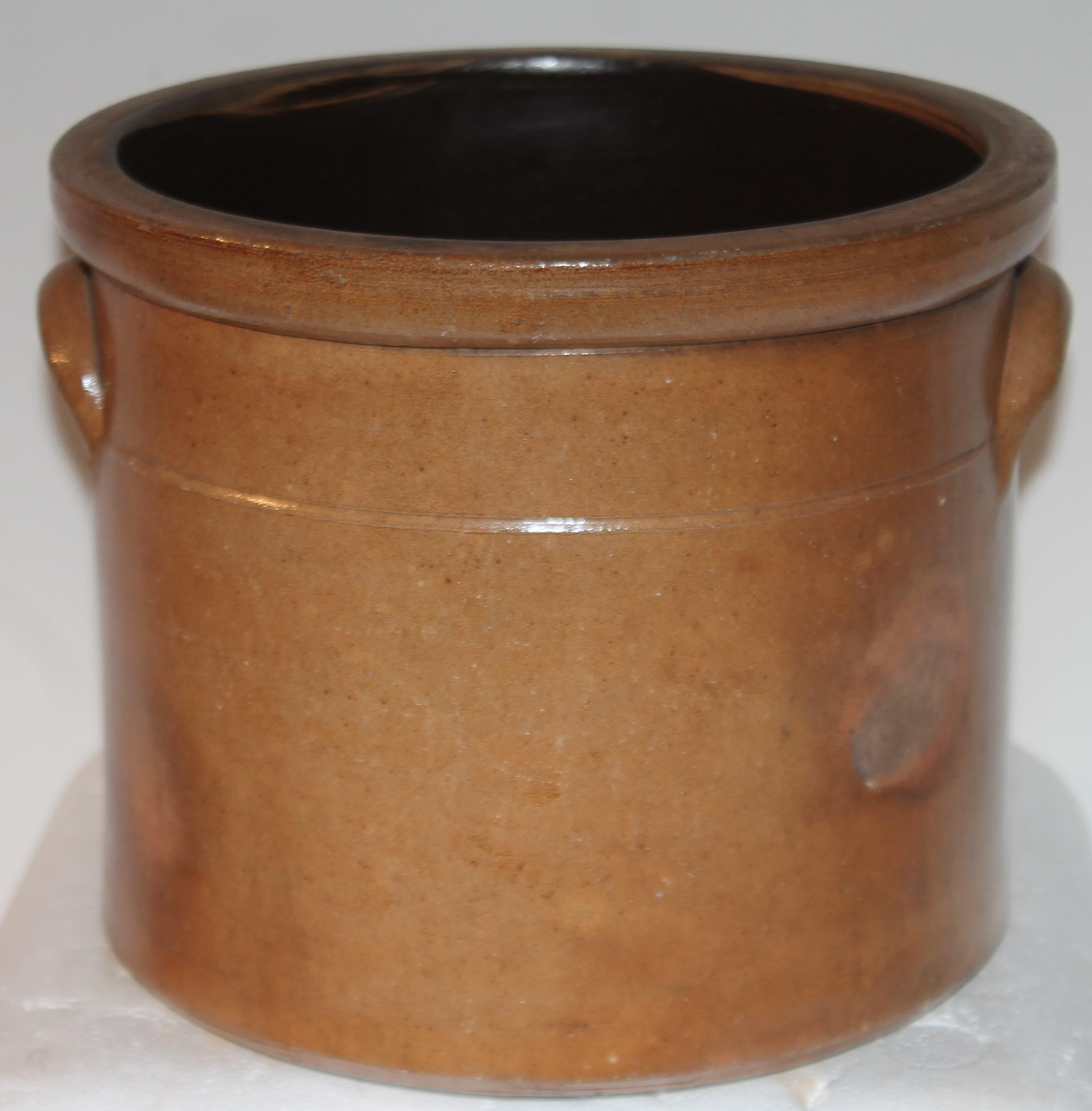 This amazing double handled 19thc Evan Jones ,Pittston ,Pennsylvania hand decorated stoneware crock is a one gallon and in mint condition. Most unusual brown glaze surface done in the firing.