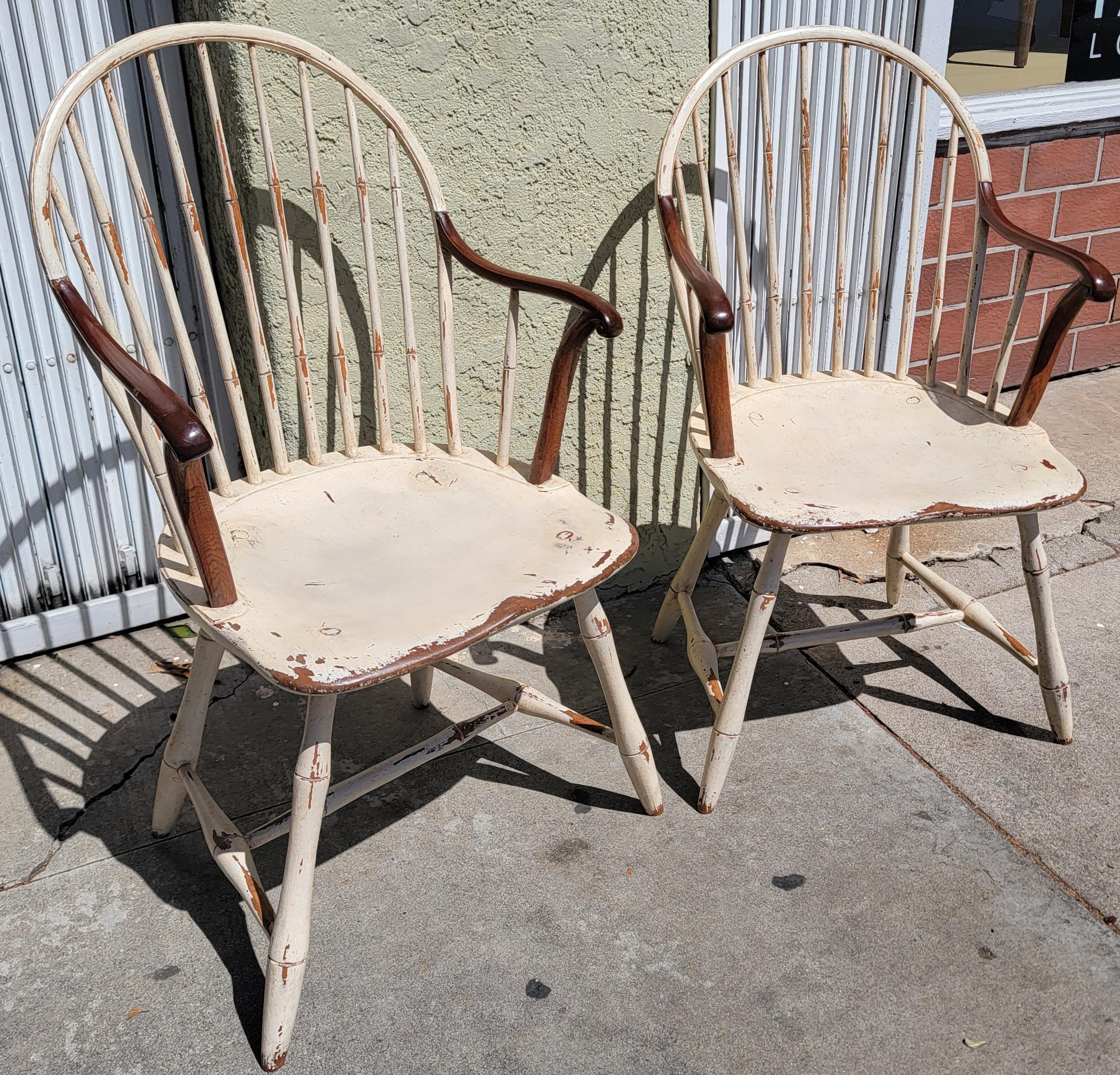 19th C extended arm Windsor chairs in a white painted surface from Philadelphia and in fine condition.These chairs are so comfortable and sturdy.Sold as a pair only.