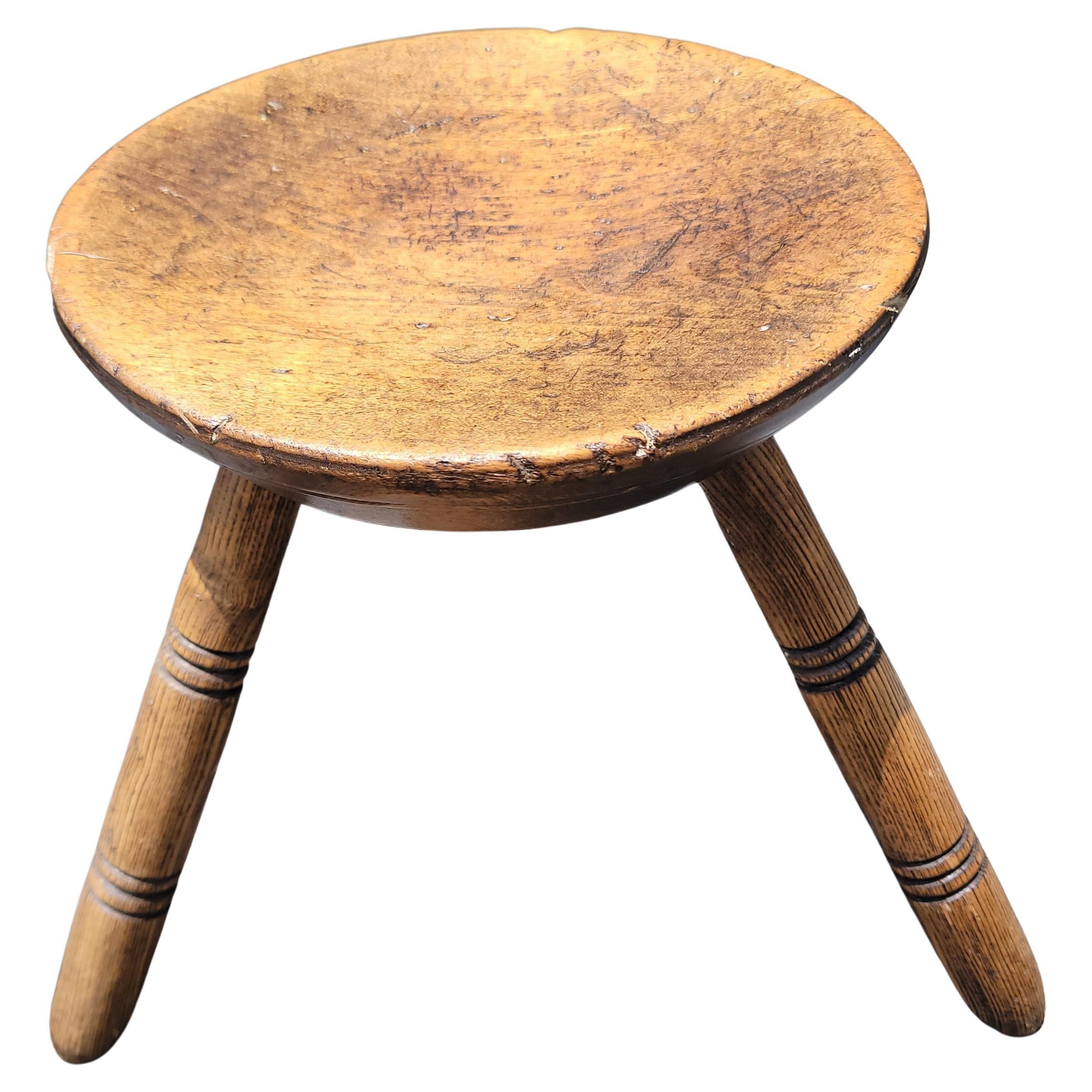 19Thc Plank Seat stool with three legs similar to shaker style.This super comfortable milking stool is in great condition with a nice mellow patina.