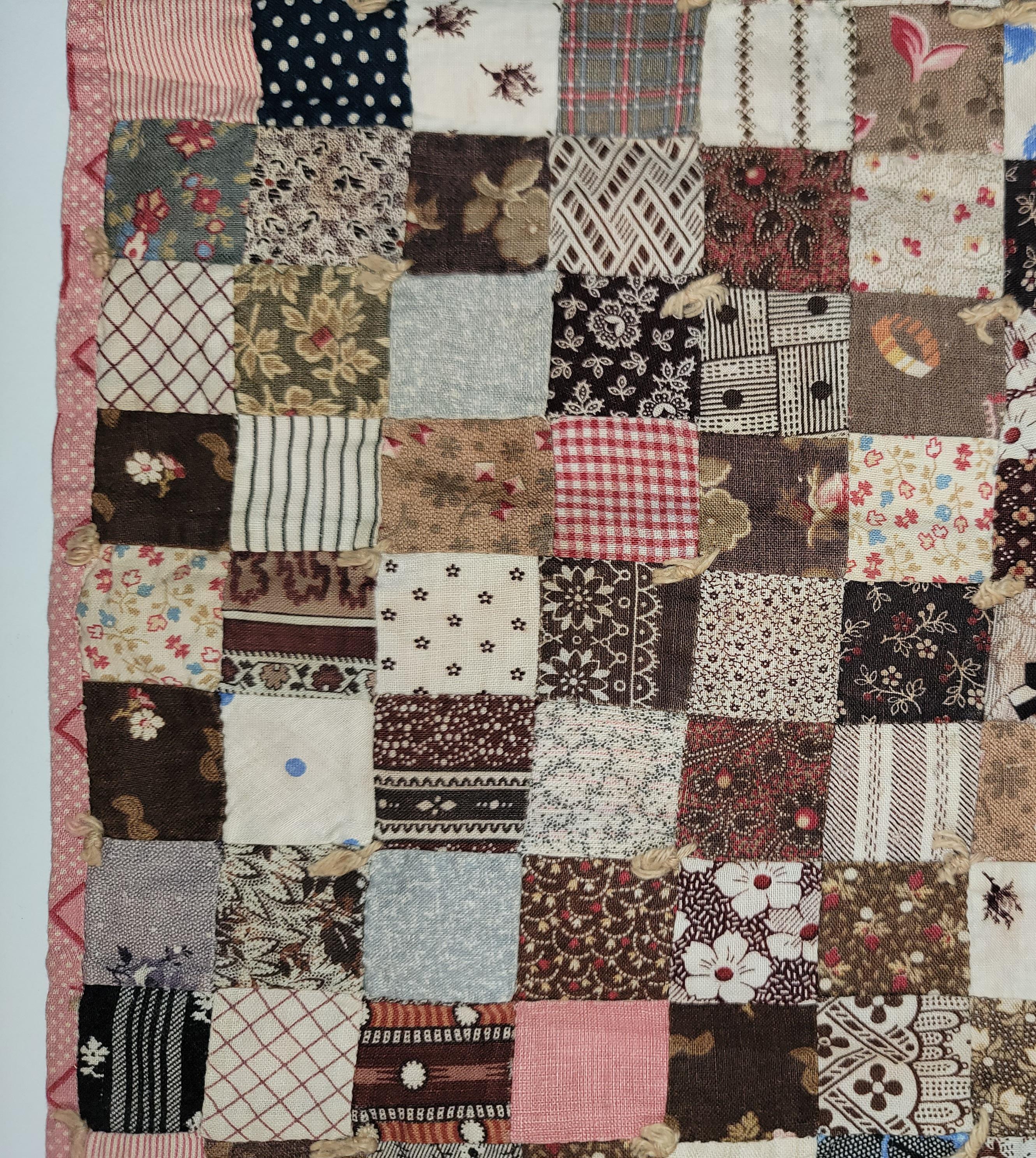 This fine 19thc postage stamp doll quilt is from Lancaster County,Pennsylvania and dates back in the late 19thc.The condition is very good and pristine.It is a hand pieced doll quilt with little hand ties all original.