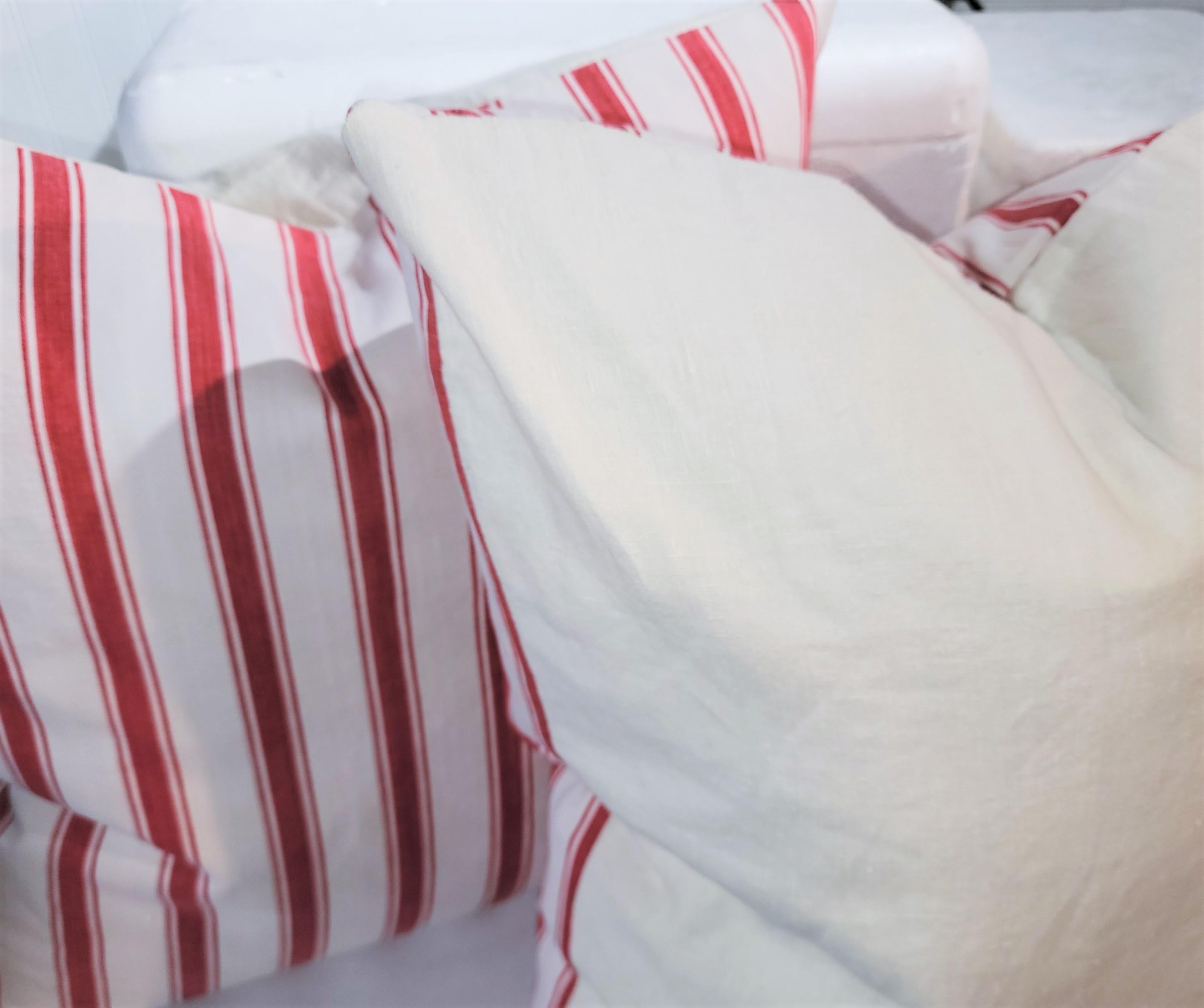 These 19thc red & white ticking pillows have white linen backings.The inserts are down & feather fill. Great used condition! 