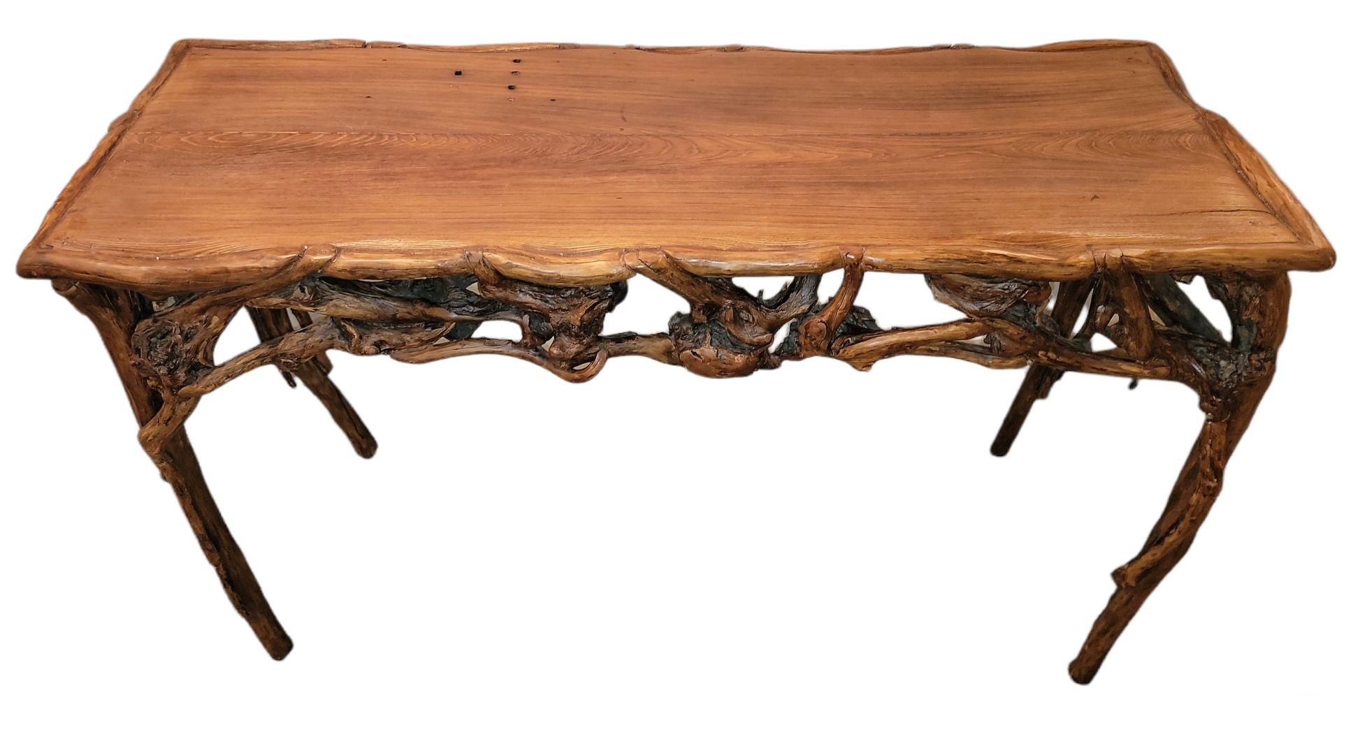 This fine folk art console table is all made up from root and twig. This console table has a old aged oak top and is in fine condition. Found on a ranch in Texas.