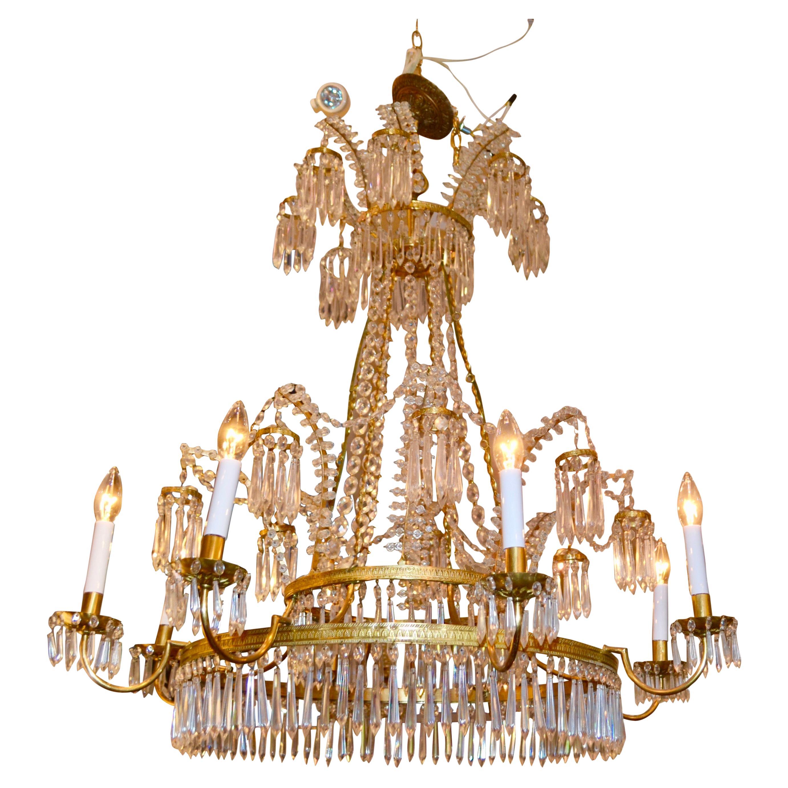 A wonderful example of a Baltic/Russian crystal and bronze chandelier the style of which is pure early 19thC. Three gilt bronze rings support lower hanging crystals as well as an upper spray of 'waterfall' design branches holding small crystal