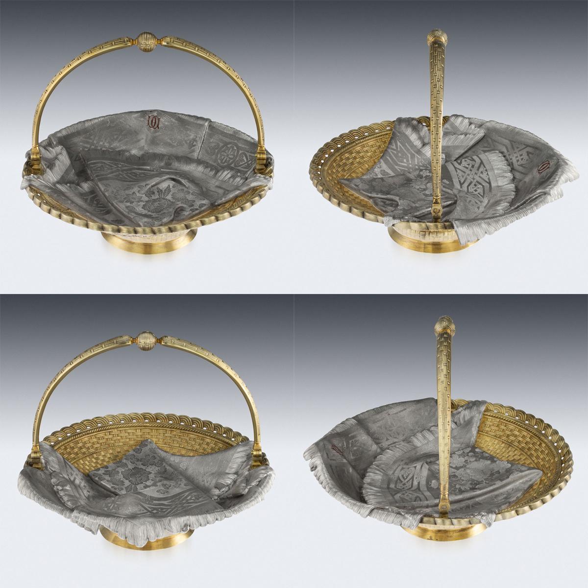 Antique 19th century Russian solid silver trompe l'oeil pair of bread baskets, large and of heavy gauge, of oval and round form, both embellished with a fringed cloth on woven ground, the smaller flanked by a pair of ropetwist handles and raised on