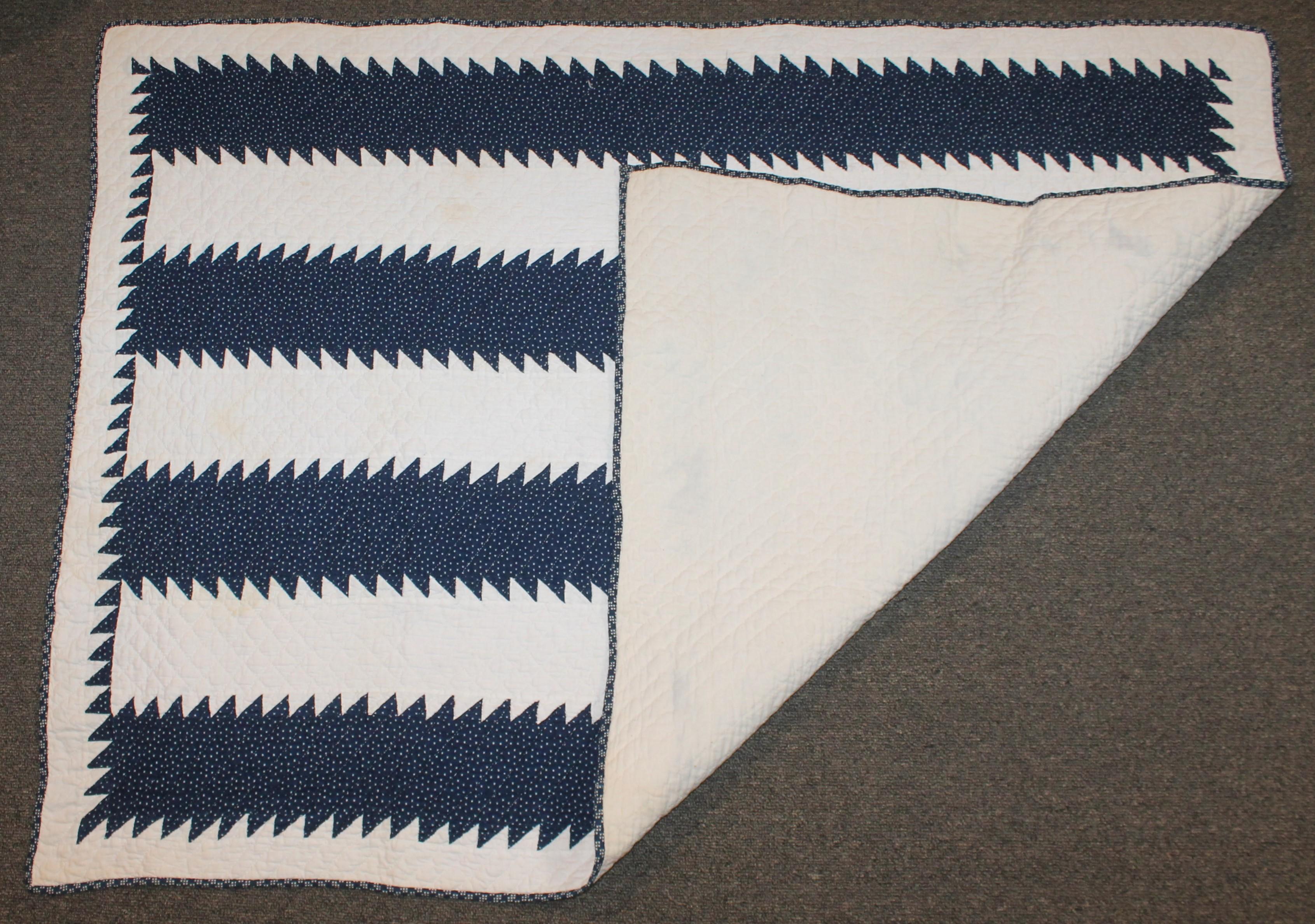 This 19th century blue calico saw tooth bars crib quilt is in pristine condition. This is quite unusual to find in a crib quilt. The saw tooth inner border is a fantastic added feature to complete the pattern of the crib quilt.