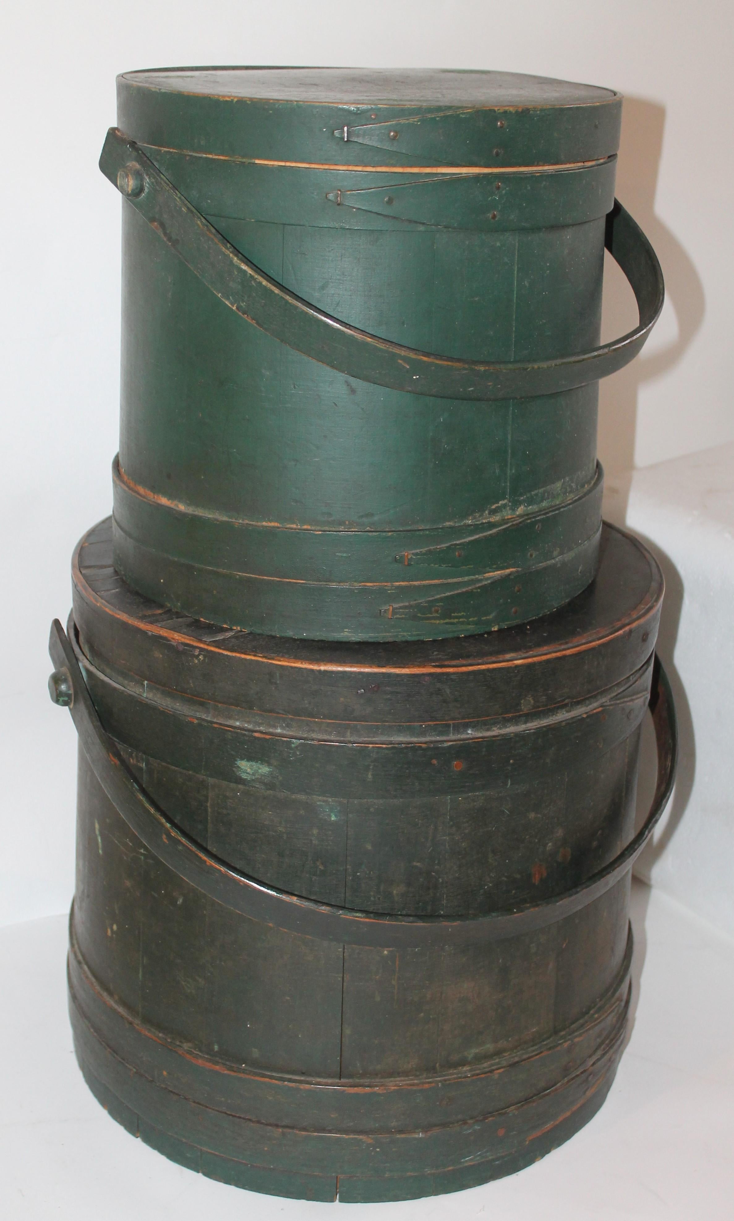 These two original painted green furkins are in good condition and are early cut nail construction. One is signed by the maker Murdock JN. Top smaller green bucket is in fantastic condition. The largest one, bottom bucket has a couple small tine