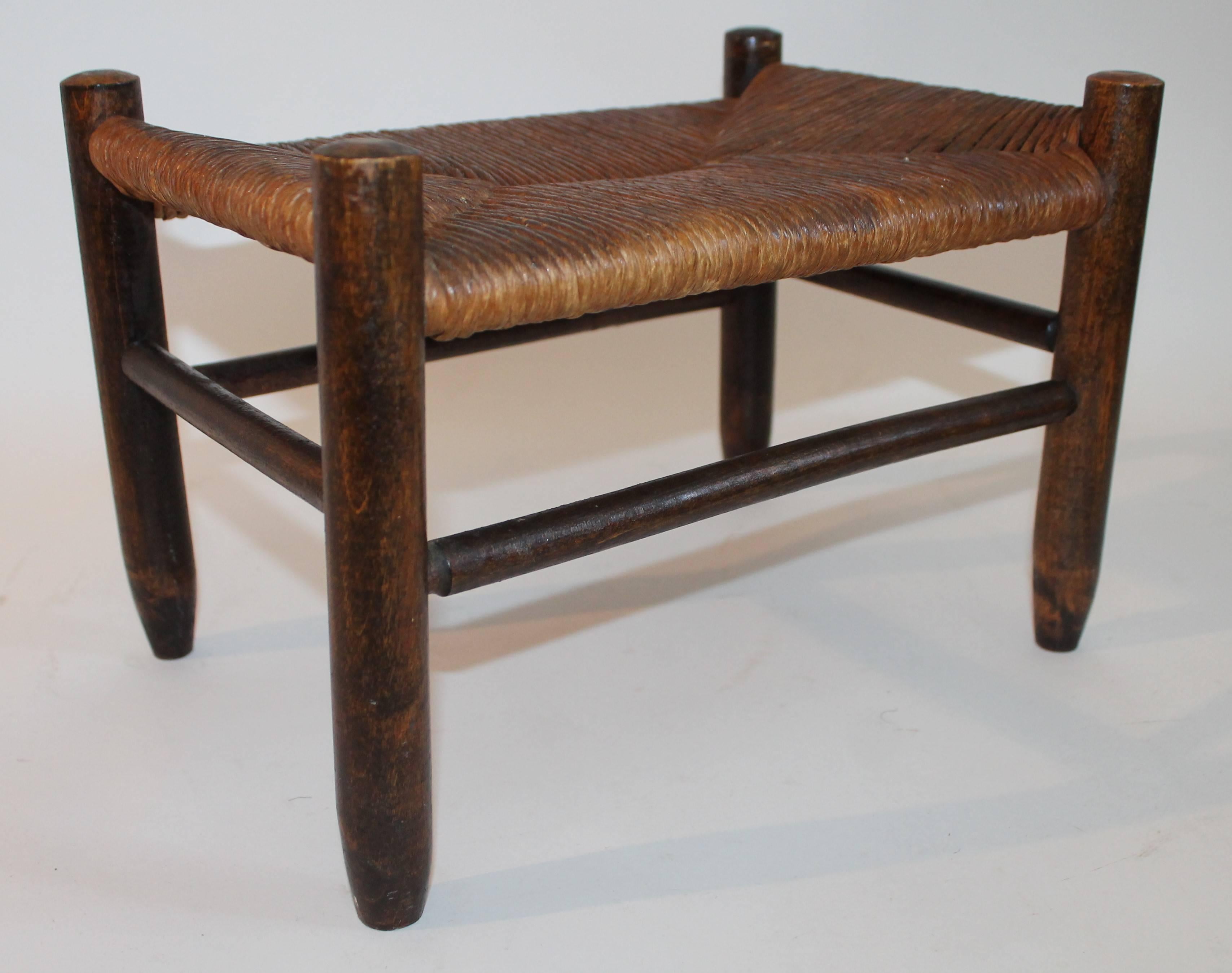 This 19th century Shaker style foot stool is in fine condition and has a handwoven top.