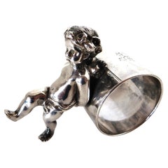 19thC Silver Plated Victorian Figural Napkin Ring; "Winged Cherub Pushing Ring"