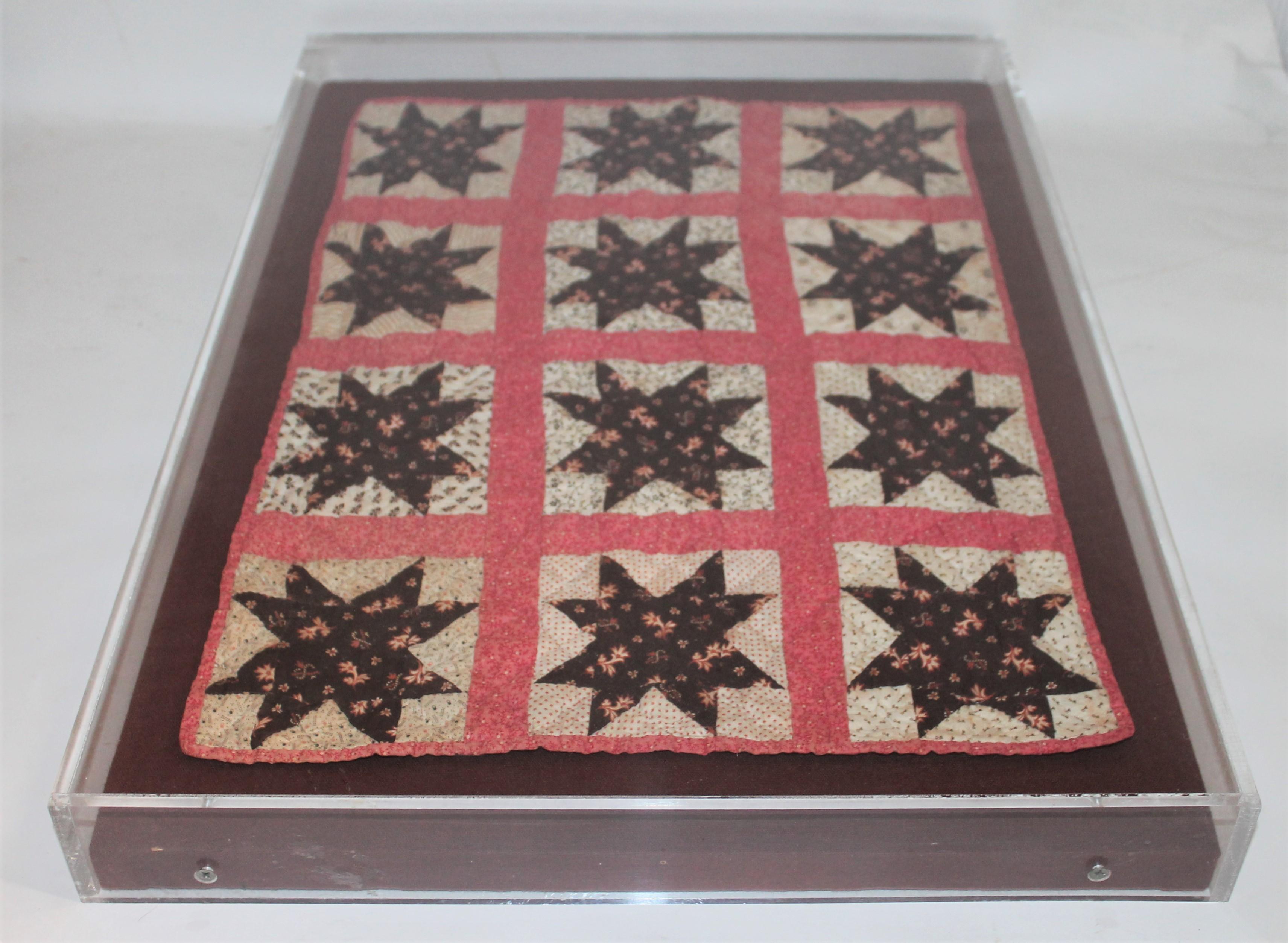 This super rare doll quilt is in great condition and is prof. mounted in a plexy. Amazing color and six point star contained within the lines. Made from cotton and placed on a custom made linen stretcher.