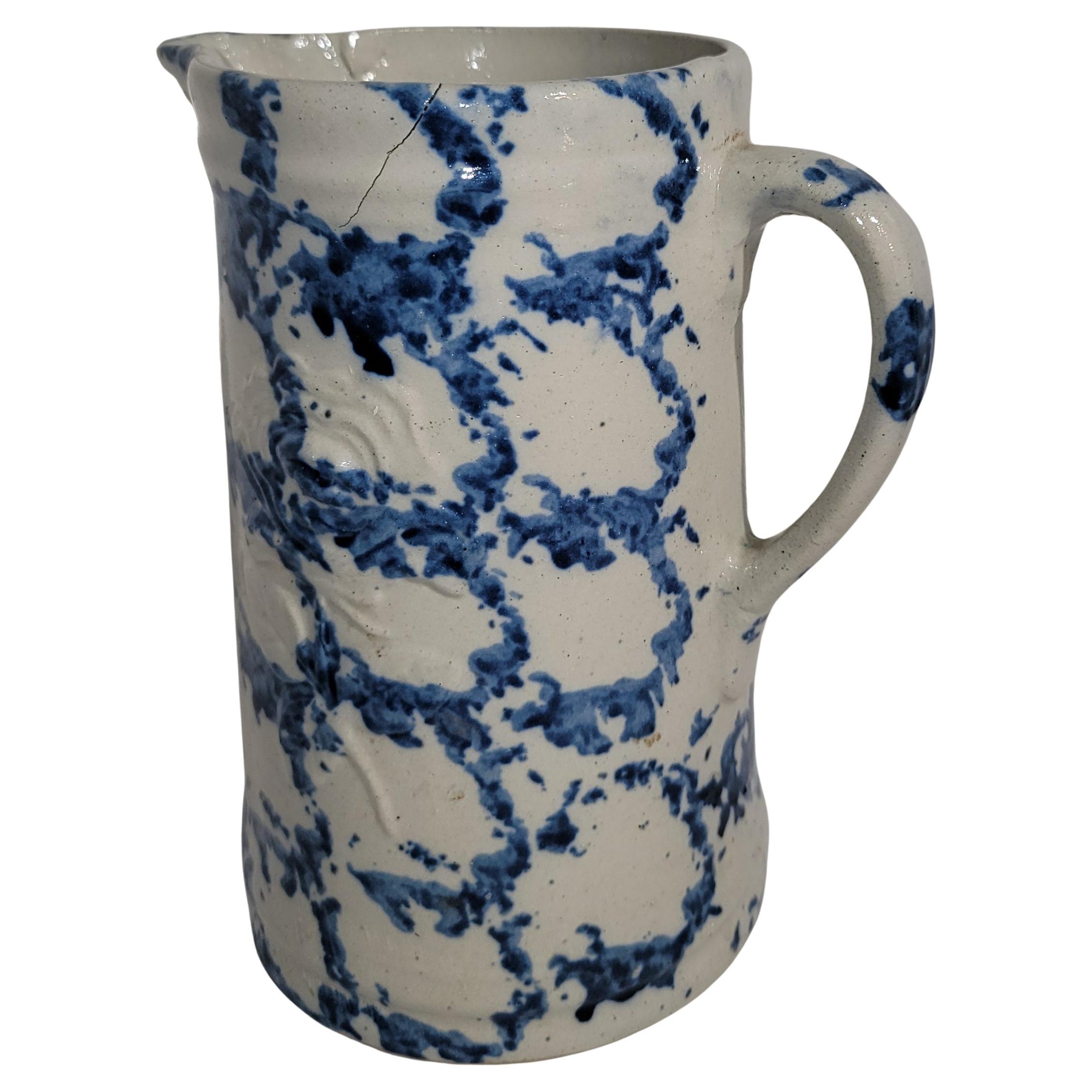 19thc Smoke ring pattern stone ware sponge  water pitcher.The condition is very good with a minor spider in the making.Take notice to the floral embossed are in the middle of the pitcher ,a faint pattern.
