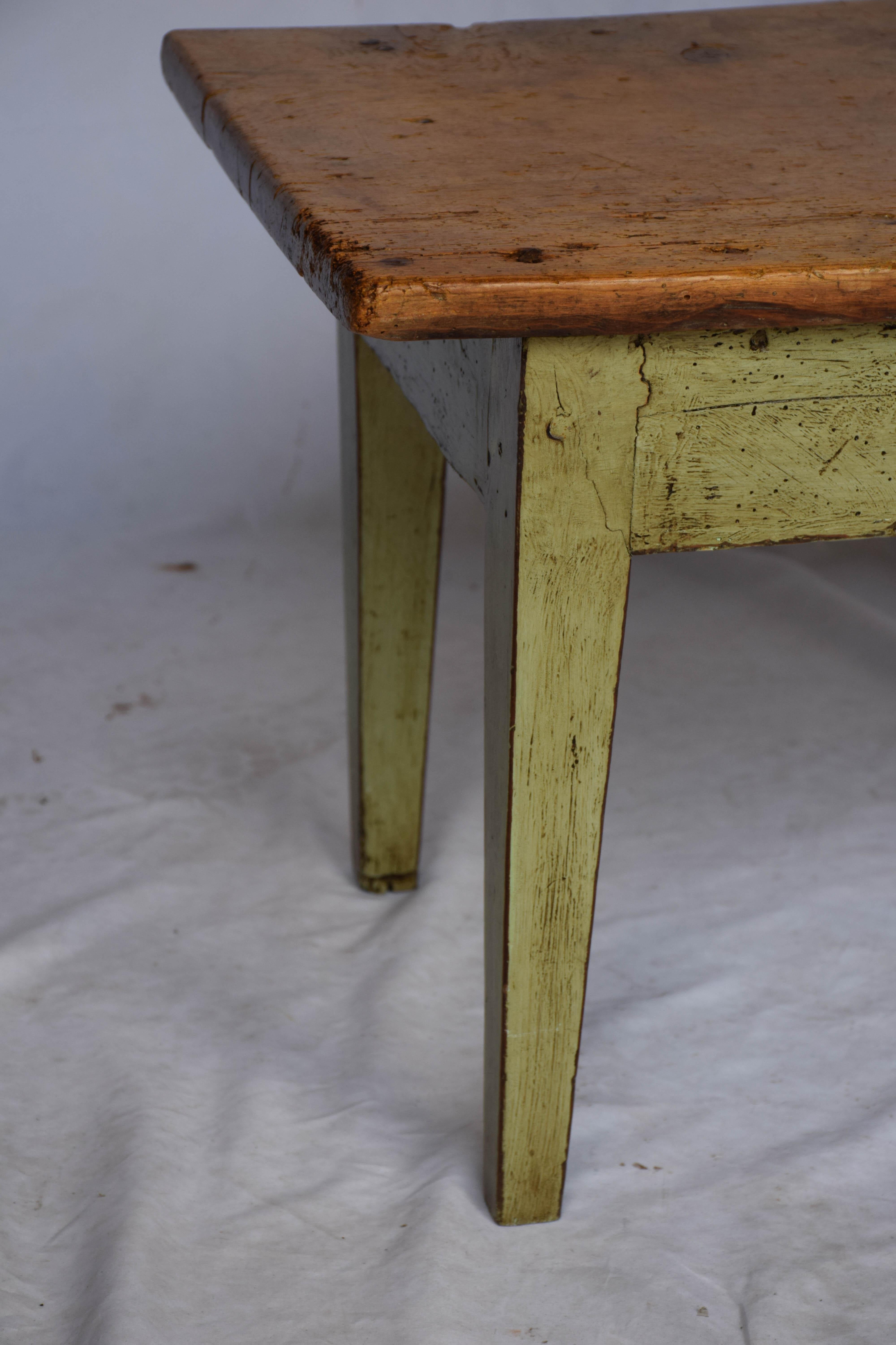 This small Spanish low table can be used as a coffee table or a side table. The top is a natural finish wood and the bottom portion is painted a soft green. This petite table could be at home in many spots.