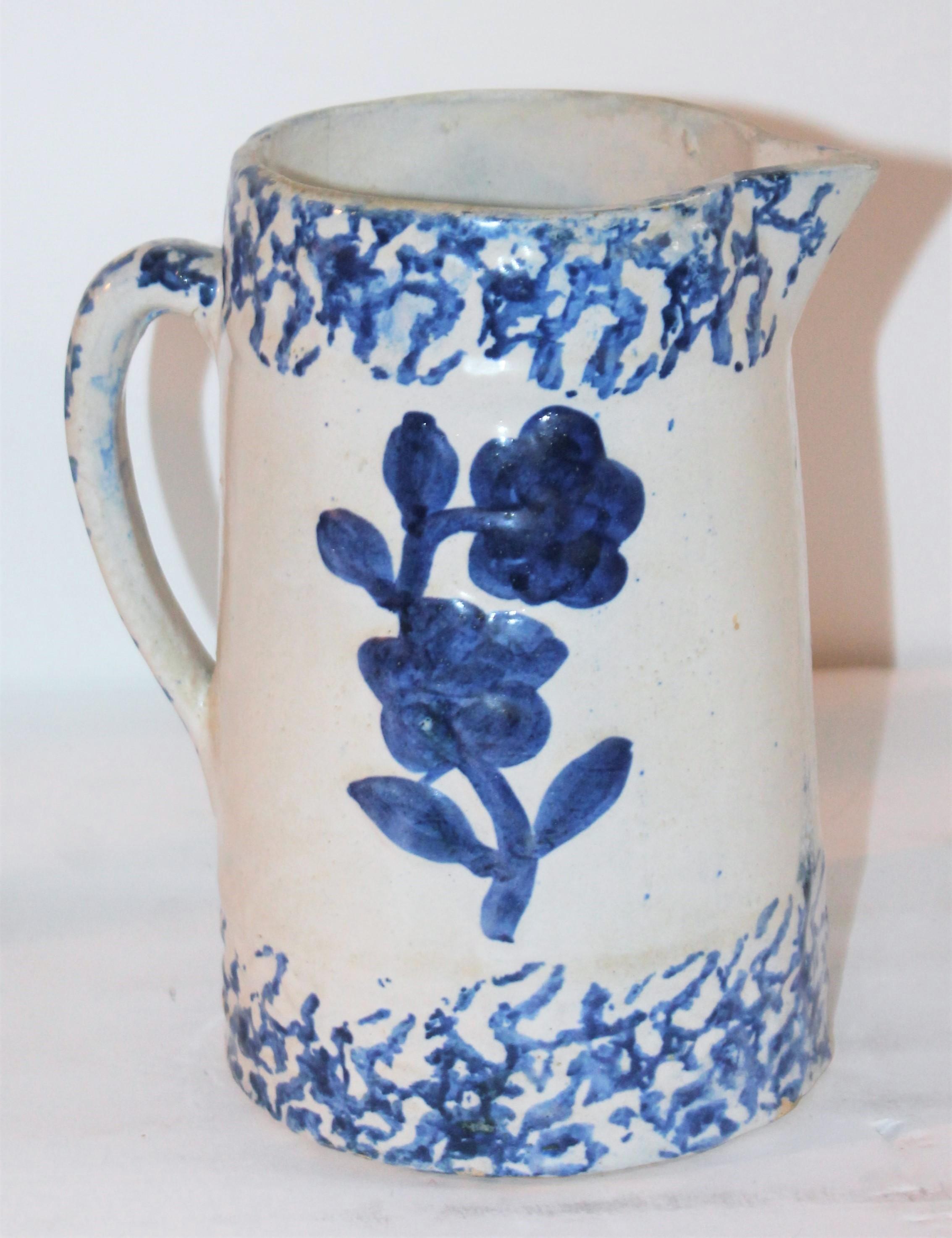 This 19th century sponge ware pitcher with floral design in good condition.