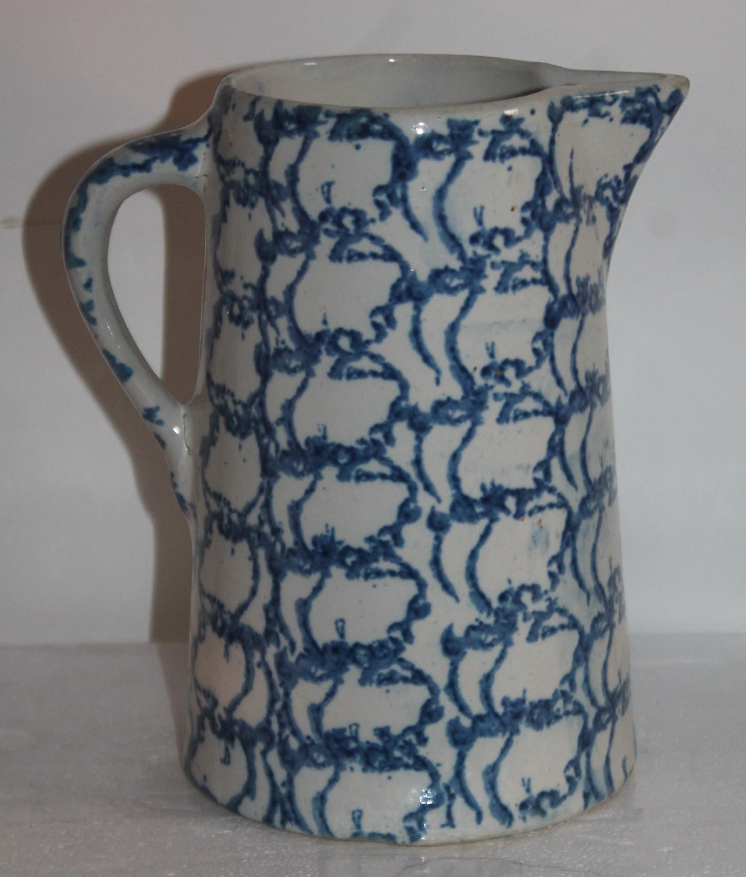 19th century sponge ware pottery pitcher in a design sponge pattern has a small chip on the inside lip. Rings like a bell with no cracks.