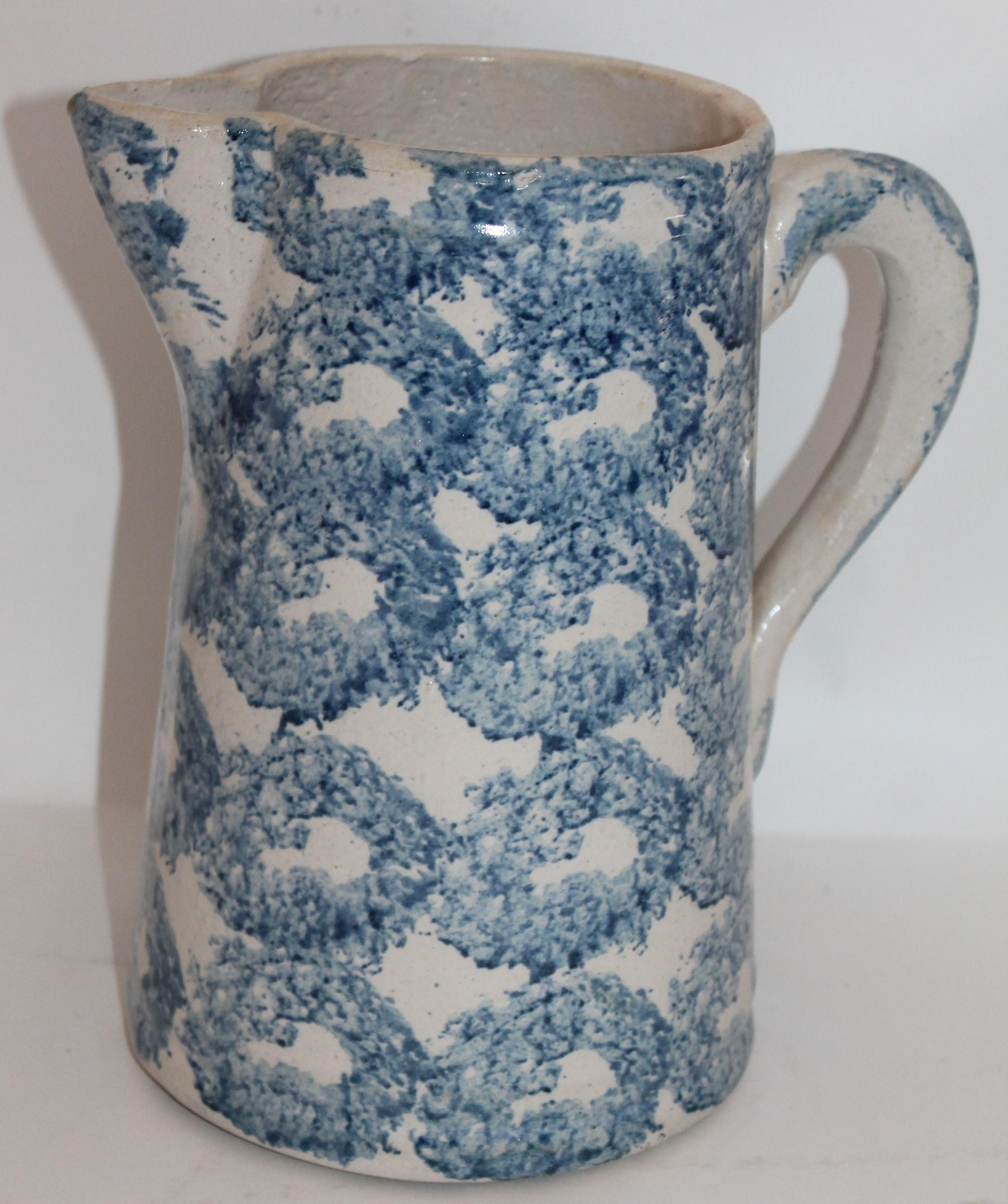 This fine 19th century sponge ware pottery pitcher is in fine condition and has the smoke ring pattern. Great shade of blue and great weight. Great for flowers on a table.