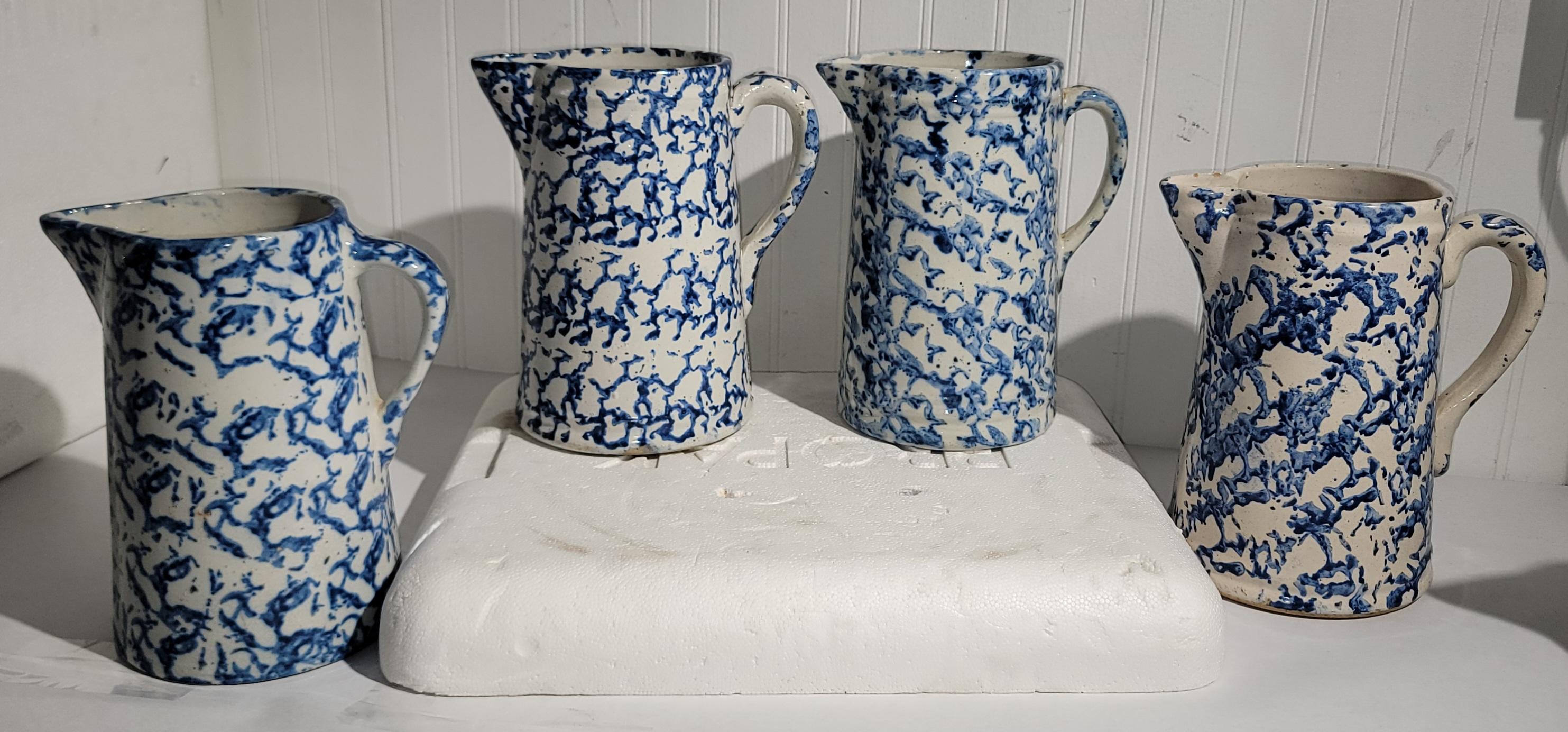 Set of Four 19thc Blue and white Sponge ware pitcher. This collection of four sponge ware  pottery pitchers are in fine condition and all vary in blue colors.Sold as a collection of four.