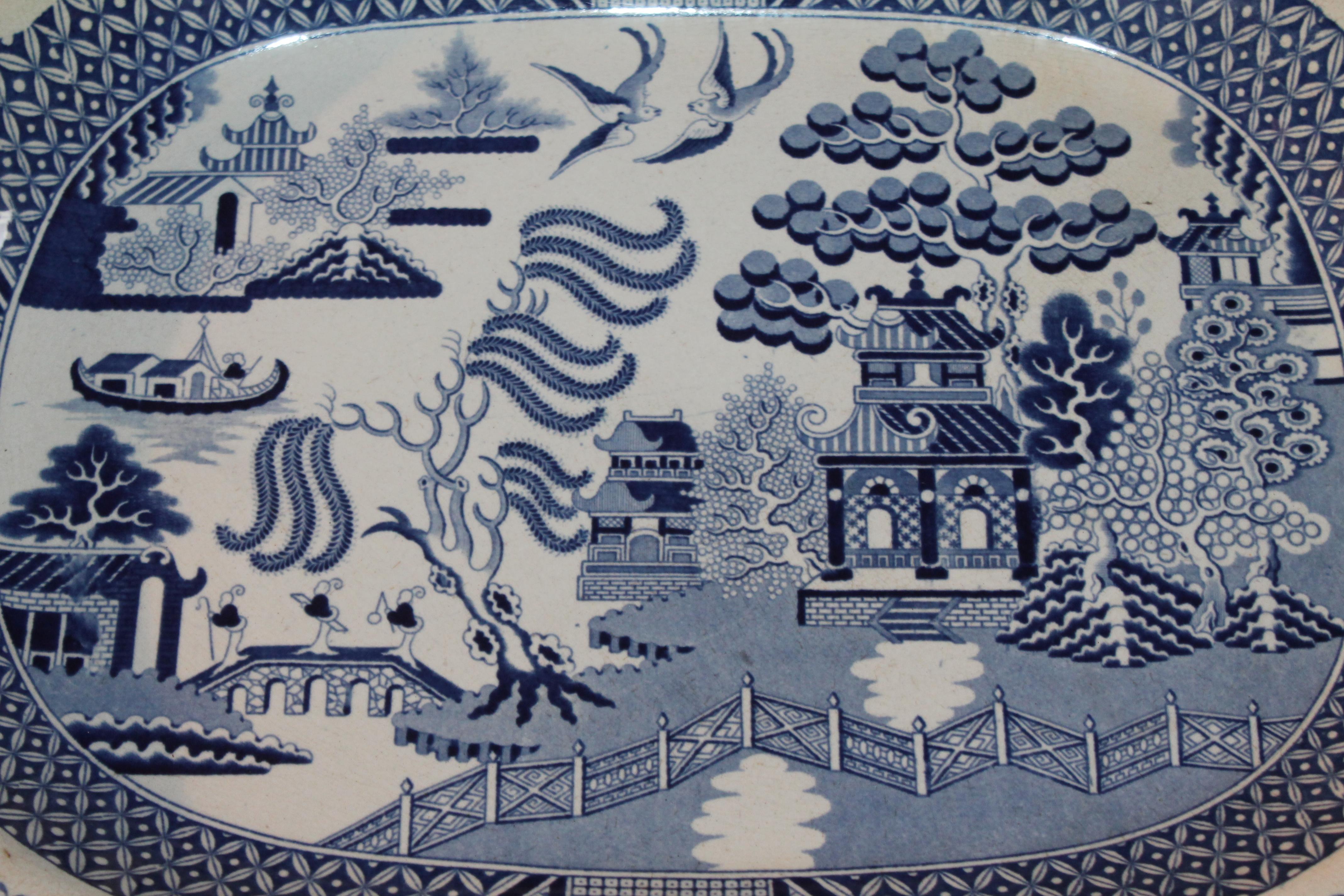 This 19th century large blue willow serving platter is signed Staffordshire, England. The condition is in mint condition.