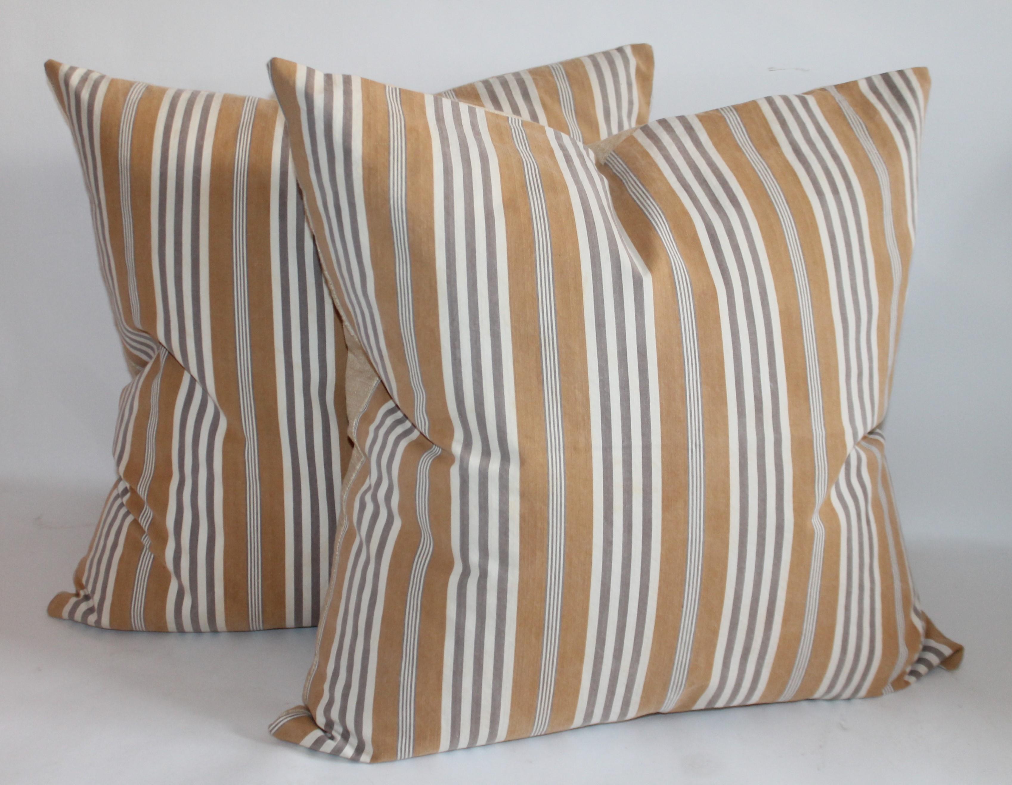 Larger pillows measure 22 x 22 goldish /tan with grey and white striping.
Smaller pillows measure 20 x 20 yellow and narrow blue and white stripes.