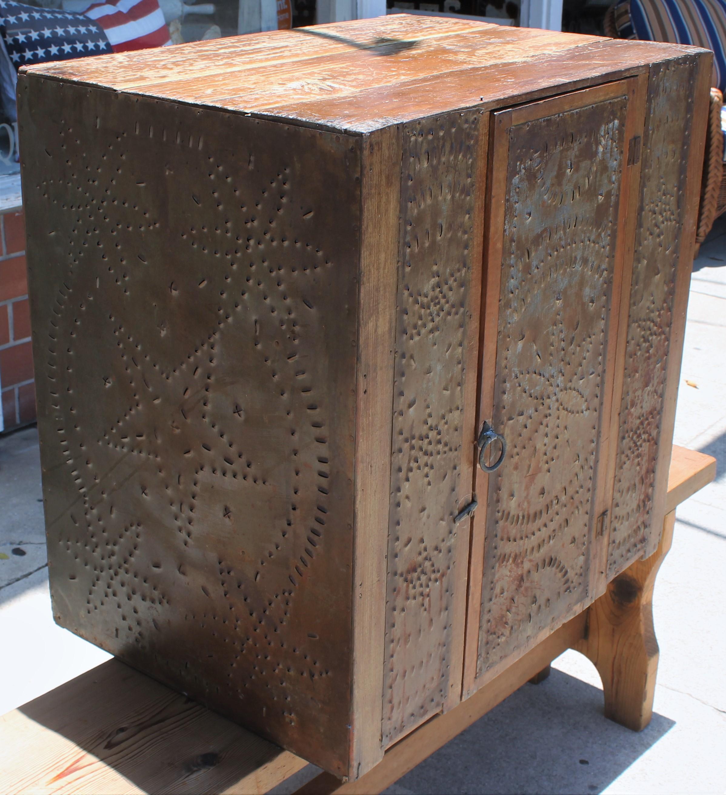 This fantastic table top punched tins pie safe that was found in East Tennessee is in fine condition. The door and shelf's are all in good condition.
